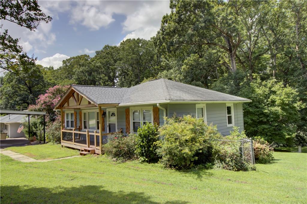 MOVE-IN READY FIXER-UPPER SPECIAL IN SOUGHT-AFTER SUWANEE!
Discover an exceptional opportunity in the heart of Suwanee, Georgia, with this 3-bedroom, 1-bath property. Perfect for those looking to add their personal touch and build equity, this home combines a fantastic location with a solid foundation. Enjoy natural hardwood throughout the house and upgraded cabinets in the kitchen. Ceiling fans are installed in every room for comfort. The kitchen comes equipped with a stove and microwave, and conveniently connects to a combined dining area. Please note, there is no dishwasher or refrigerator. The outdoor space features a lovely deck that extends off the back porch, offering a perfect spot for relaxation, overlooking a large, fenced-in backyard that backs up to a serene creek. The property also boasts an unfinished basement, providing ample space for future expansion or customization. Utilities include a natural gas water heater and a fully functional, hard-wired generator, ensuring peace of mind during any power outages. You'll enjoy the easy access to local parks and attractions such as Suwanee Town Center, Suwanee Creek Greenway, and Sims Lake Park. Priced to sell. Be the first to see it.