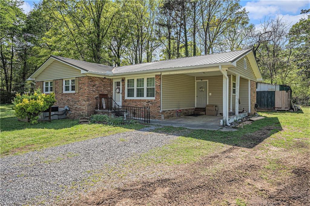 Charming Brick Ranch on a Spacious Corner Lot! Welcome home to this beautifully updated 3-bedroom, 1.5-bath brick ranch nestled on a large, fenced-in corner lot - perfect for pets, kids, and privacy lovers alike! Step inside and fall in love with the warm and inviting mix of natural pine and sheetrock walls, giving the home a unique rustic-modern charm. The updated kitchen features stunning quartz countertops, sleek cabinetry, and modern fixtures - a true chef's delight! The main bath includes a luxurious walk-in tile shower that adds a touch of spa-like comfort to your daily routine. Outdoors, the property shines with a fantastic entertainment area, ideal for hosting friends and family - or just relaxing under the stars. This home offers comfort, character, and convenience all in one place. Don't miss your chance to tour this Northwest Georgia gem!