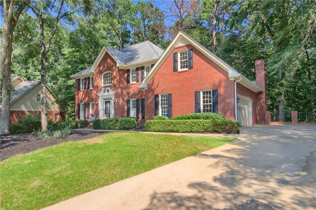 Situated on 1.2+/- acres on a quiet cul-de-sac street in Johns Creek’s Prestwick, this brick traditional home was lovingly cared for by its original owners, and has just gone through a wonderful renovation. The timeless façade includes dentil molding on the eves, a swan neck pediment above the door and sidelight windows around the door, allowing additional light into the two-story foyer. The interior includes new hardwood floors, new plush carpet, extensive molding and large rooms. Enjoy a formal living room, dining room with a bay window, an eat-in kitchen with abundant storage and a sprawling great room with a cathedral ceiling, wet bar, and access to the screened porch. The main level also includes a guest suite, a laundry room with a utility sink, built-in cabinetry and access to the two-car garage. Upstairs, the primary suite consists of a large bedroom, a dressing room, a new en suite bathroom with separate vanities, a separate shower and a large walk-in closet. Two additional bedrooms share a hall bathroom and complete the upstairs. The newly finished daylight basement offers tons of storage space, a large recreation room with a masonry fireplace, and a full bath. Enjoy access to the rear covered patio and backyard from the basement as well. This home has been well-maintained and has great bones! Located in the Medlock Bridge Elementary, Autrey Mill and Johns Creek High School district, the neighborhood is also close to area country clubs, retail, restaurants, top private schools and so much more!