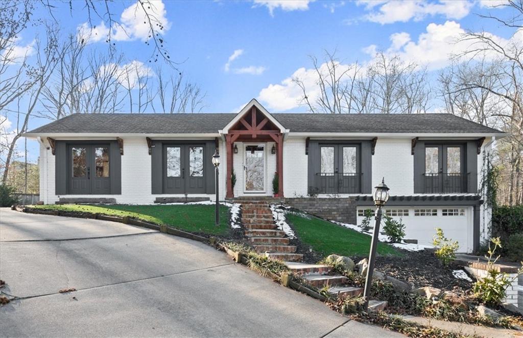 Welcome home to this gorgeously renovated, 4 sided brick ranch home on a full basement and nearly an acre lot with no HOA! Main floor is a bright, open floor plan made for easy living and amazing for entertaining. Newer white kitchen cabinets, stainless steel appliances, granite counters, subway tile backsplash and a large island facing living room will wow you! Living room is centered by cozy fireplace and has sleek built in bookshelf, and there's a generous space for dining. Off the back of the home is an expansive sunroom with another fireplace, makes for a large additional living or dining space and take in private backyard and Trex deck! Secondary bathroom down the hall has been recently renovated with new tile and vanity, and owners suite is something special. The primary bedroom offers a walk in closet and tastefully updated master bathroom with custom barn doors for both, and a charming window seat to overlook the back of the property. Lower level offers another living area and a 3rd (yes, 3rd!) fireplace, as well as a modern and beautiful laundry room and another secondary bedroom with recently renovated bathroom. The property has an enclosed yard right off the deck, and also the lot behind (can gain access by driveway path to right side of home), full of possibilities. There's an incredible amount of parking here with a gravel parking pad to the left of the home with tons of space for vehicles, boats, RVs, etc. And while it feels private and secluded, you're centrally located in East Cobb with all the perks (awesome schools, restaurants, shopping and more) with easy highway access as well as just 10 minutes from the Marietta Square!