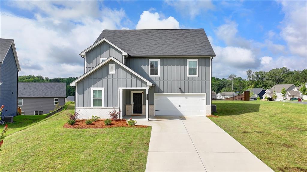 Experience the ideal combination of comfort, lifestyle, and contemporary living in this beautiful home in Dawsonville, just 2 miles from Highway 400 within the highly desirable Dawson Grove community. Perfect for families, this home provides exclusive access to a private side entrance leading to Blacks Mill Elementary School. For outdoor enthusiasts, the Dawson Forest mountain biking trails, and Lake Lanier are nearby, offering ample opportunities for adventure. Shopping and dining are also just a short drive away at the North Georgia Premium Outlets. This home is ideally situated on a NORTH FACING, CORNER lot at the end of a cul-de-sac, one of the largest in the community, offering privacy and expansive outdoor space. The house is elevated at a high-rise altitude, giving you clear open views. Inside, you'll find a beautifully upgraded washroom on the ground floor, adding a touch of modern luxury. The home features the highly sought-after Jordan floor plan with a spacious, open-concept design. The chef’s kitchen includes a large island with granite countertops, sleek white cabinetry, and a full tile backsplash, all open to the great room, which boasts a striking floor-to-ceiling fireplace. Luxury vinyl plank flooring flows effortlessly through the main level, bathrooms, and laundry room. The generous primary suite offers a walk-in closet and a private bath with a walk-in shower and linen closet. A conveniently located oversized laundry room serves the upstairs bedrooms. With five bedrooms in total, including a guest suite on the main level, there’s plenty of room for family and guests. The Dawson Grove community provides a friendly atmosphere with sidewalks, streetlights, and a large pool with a cabana, with the added benefit of an internal road from the community directly to Blacks Mill Elementary School, perfect for families with small children! Don’t miss out on this rare opportunity to own a home that truly has it all!