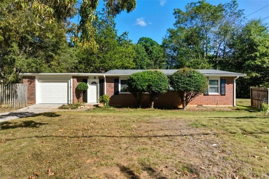 Beautifully updated 4-sided brick ranch featuring a new roof and newer windows. This home offers vaulted ceilings throughout and faces Westwood Drive, providing plenty of parking and privacy. Absolutely turn-key and move-in ready — this home shines! Features include gleaming hardwood floors, granite countertops, custom cherry cabinets, stainless steel appliances, and new dishwasher. The open floor plan allows the kitchen to flow seamlessly into the living room, perfect for entertaining. A spacious deck off the kitchen offers an ideal space to relax or host guests. The primary suite features a tiled bath, and the guest bedrooms are well-sized with ample natural light. Conveniently located close to Emory, CDC, and all major interstates. This is a great place to call home!