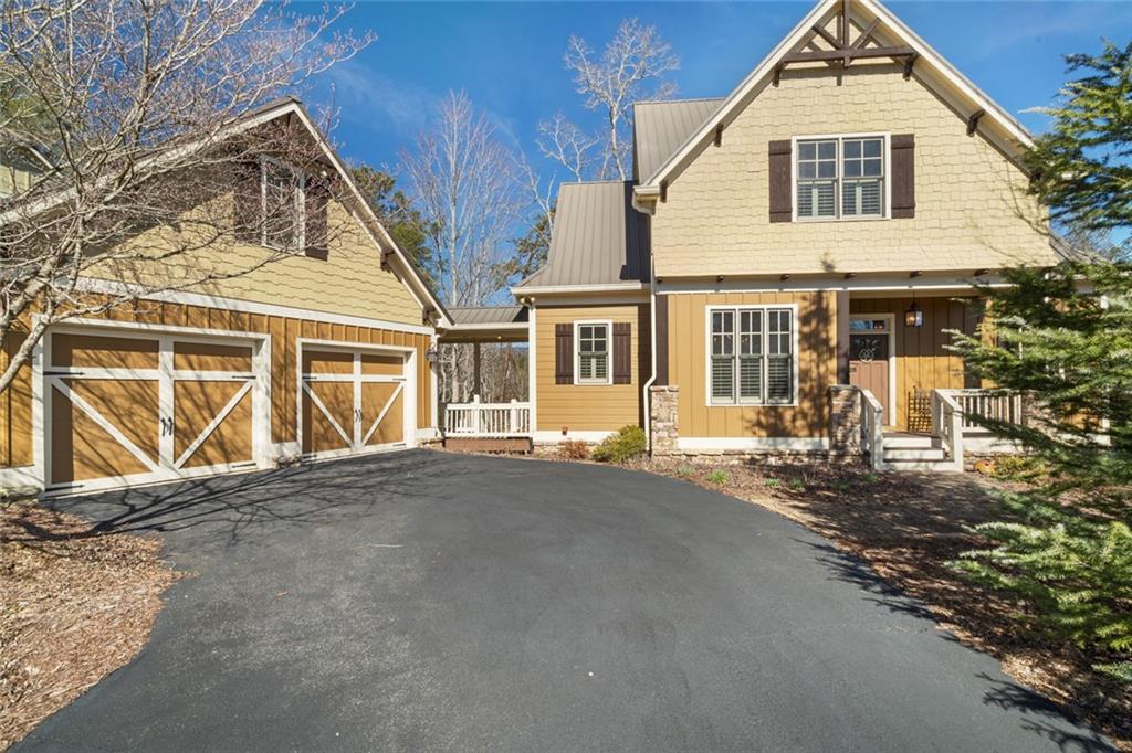 Welcome to this spectacular home, perfectly positioned to offer breathtaking views of the lush golf course, serene Disharoon Creek, covered bridge, and majestic mountains. As you enter the main level, you'll find a cozy living room with a fireplace, dining room, and a well-appointed kitchen, all designed for both comfort and elegance. This level also features the primary suite, a powder room, convenient laundry room, and a large sunroom with a gas log stove that overlooks the fairway, with the mountains providing a stunning backdrop. Upstairs, the loft area offers additional living space, along with a guest bedroom and a full bath, ensuring privacy and comfort for visitors. The terrace level provides a casual living space, another guest bedroom and full bath, a large, screened porch, and a generous storage room—ideal for all your needs. Step outside to the deck off the garage, where you can enjoy the peaceful beauty of your backyard oasis. The professionally landscaped backyard, filled with flowering shrubs, leads to steps that take you directly to the golf course, making it easy to enjoy the outdoors. Nestled in the charming Twin Creeks community within Big Canoe, this home is one of just 13 residences, creating a close-knit neighborhood with friendly neighbors. The community features a gazebo and creek side bench in the cul-de-sac, and is just minutes from the main gate, clubhouse, and all the incredible amenities Big Canoe has to offer. This is truly an opportunity you don’t want to miss! *Buyer to verify all information and dimensions deemed important.