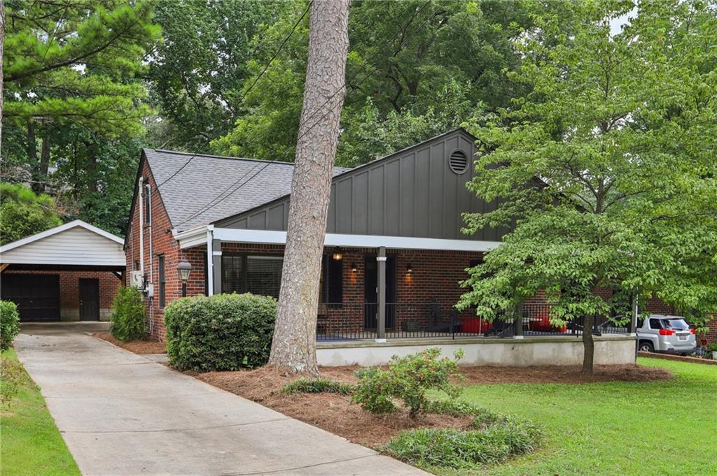 Beautifully Updated Home with Southern Charm and Modern Touches! This beautifully updated home offers bright, open spaces and timeless appeal. A sprawling Southern-style front porch stretches across the entire length of the house—perfect for rocking chairs and enjoying cool Georgia evenings. Step inside to find gorgeous hardwood floors throughout—no carpet anywhere! The sun-filled living room flows into a separate dining area, ideal for entertaining. The modern kitchen is a standout, featuring unique painted cabinetry, butcher block countertops, stainless steel appliances, and a pass-through to the sunroom that doubles as a stylish bar area. The main-level primary bedroom has convenient en-suite access to a fully updated hall bath. A second bedroom is located just across the hall. Upstairs, you'll find two generously sized bedrooms and another beautifully updated full bath, offering plenty of space for everyone! Out back, enjoy an oversized deck—perfect for grilling, entertaining, or relaxing under the trees. The detached garage with an oversized attached carport has ample parking and adds convenience, while the large, flat backyard offers mature trees for privacy and endless possibilities for outdoor fun. Updates include: renovated kitchen, new roof, brand-new deck, tankless water heater, and a new AC unit (2025). All located close to parks, top-rated schools, and local shopping and dining. Don't miss your opportunity - book your tour today!