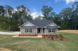 Under Construction! The 2604 floorplan, a stunning 1.5-story, brick and stone front home on a full finished basement nestled on an expansive 2.92-acre estate sized lot located at homesite 90 in Tuscany Hills, Douglasville, GA. This 5-bedroom, 4-bathroom residence offers at total of 3900 square feet of modern elegance with a thoughtfully designed layout. The open floor plan is highlighted by luxury vinyl plank flooring throughout the main living spaces and wet areas, while the bedrooms are cozy with plush carpeting. The gourmet kitchen boasts stainless steel appliances, a beautiful tile backsplash, and ample counter space, perfect for culinary enthusiasts. Enjoy gatherings by the charming wood-burning fireplace in the spacious living area or step outside to the deck, ideal for outdoor entertaining. This full finished basement offers a spacious and inviting retreat, featuring plush wall-to-wall carpeting that adds warmth and comfort throughout. The open-concept recreation room provides ample space for entertainment, whether it's a home theater, game room, or fitness area. Natural light pours in through large windows, creating a bright and airy atmosphere. A beautifully designed full bath includes a modern vanity, sleek tile flooring, and a luxurious shower, offering both convenience and style. The seamless flow from the recreation space leads to a walk-out deck, perfect for outdoor relaxation and entertaining. A side-entry 2-car garage adds to the curb appeal and functionality. You have plenty of room driveway is about 250ft plenty of room for guest. Located just minutes from I-20 West and the vibrant Chapel Hill area, Tuscany Hills offers a peaceful suburban lifestyle with easy access to shopping, dining, and entertainment. Residents of Tuscany Hills enjoy large estate-size lots, serene surroundings, and the convenience of nearby Douglasville amenities, all while being within commuting distance of downtown Atlanta. Make this stunning home yours and experience the luxury and charm of Tuscany Hills living!