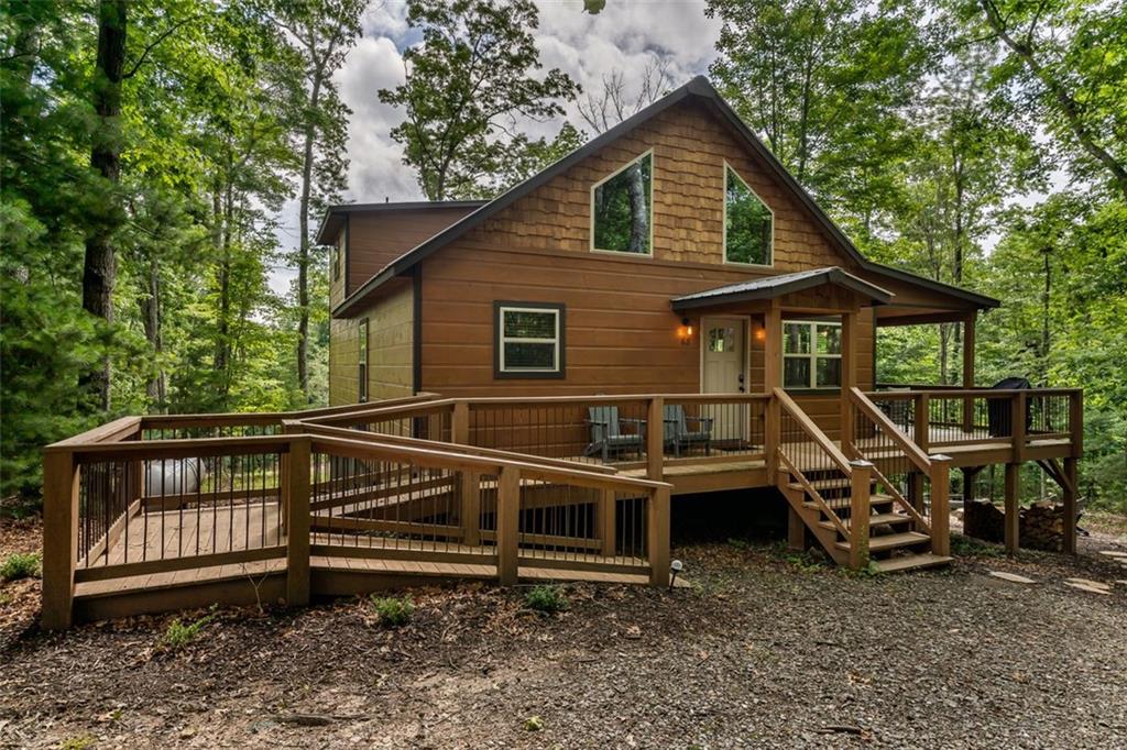 Discover Your Perfect Mountain Escape!
Tucked away in a peaceful, wooded setting, this charming mountain cabin offers the ideal blend of rustic character and modern comfort—creating the perfect retreat for relaxation, adventure, or rental income. Featuring 2 cozy bedrooms plus a versatile loft, there’s ample space for family, friends, or guests to unwind surrounded by the beauty of the mountains.
Inside, you’ll find a warm and inviting open-concept living space with a stone fireplace and expansive windows that frame breathtaking seasonal mountain views. The well-appointed chef’s kitchen seamlessly connects to the living area, making it perfect for entertaining or enjoying quiet evenings in.
Step outside to a spacious deck that offers a peaceful setting for morning coffee or sunset cocktails. A private hot tub awaits—perfect for soaking under the stars while enjoying the crisp mountain air and natural surroundings.
This cabin also features a brand-new generator with a transferable warranty, providing peace of mind in any season.
Whether you’re looking for a personal sanctuary or a smart investment, this property offers strong potential as a vacation rental, with rental history available upon request. Additionally, furnishings are available under a separate bill of sale, making this a truly turnkey opportunity.
Don’t miss your chance to own a slice of mountain paradise—where comfort, charm, and income potential meet in one unforgettable setting.