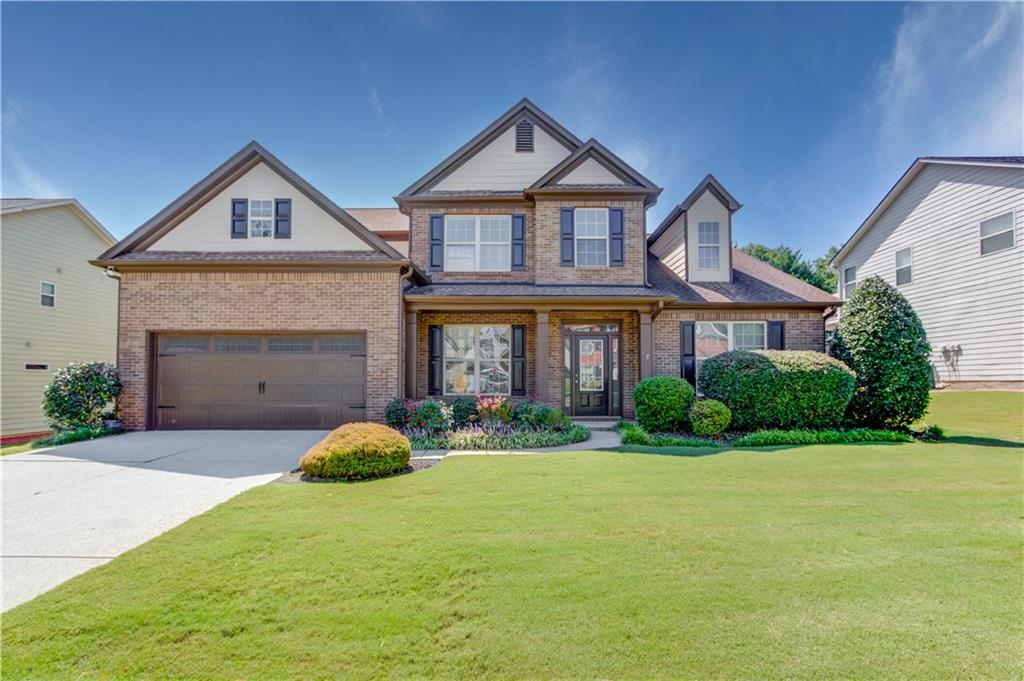 Amazing house in a quiet subdivision near neighborhood shopping, a beautiful county park, and convenient to Interstate 85, Highway 316, and the Mall of Georgia. The main level features a grand 2-story entrance foyer, formal dining room, and massive open kitchen that features ample cabinetry, a gas cooktop, wall oven, built-in microwave, and large island that overlooks a keeping room area with dual sided fireplace. Additional main level features include a two story family room with soaring windows, a primary bedroom with hardwood flooring, spa type bath with soaking tub, separate shower, large walk-in closet. Last, the laundry room is large and has a lot of cabinetry, and there is a powder room guest bathroom. The upper level features a second full suite with walk in closet and full bath, the additional two bedrooms share a bathroom between them. The rear yard is private and has a wooden privacy fence.