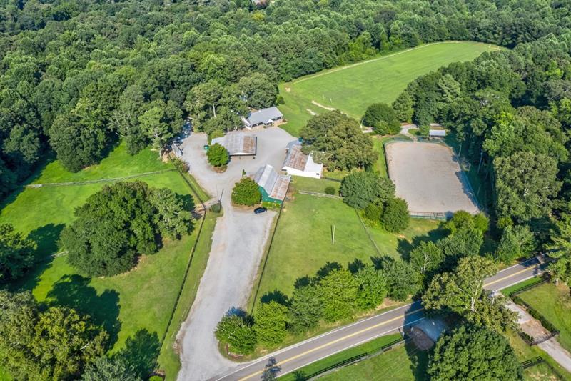 Chukkar Farm encompasses 67 +/- acres in the heart of the Sweet Spot of Cherokee. Own a piece of history and take over the reins to this spectacular farm with endless options for end-use. Polo Field 360' x 750', arena 80' x 120', three homes, barns, sheds, venues, and open-air barns are included in this assemblage of properties.  Little River runs through the rear of the property, highlighting abundant wildlife, fertile pastures, and trails for riding and hiking—an incredible location with Alpharetta address ~Cherokee County taxes. Additional properties included in the assemblage~ are 1399 Liberty Grove Road and 1140 Liberty Grove Road. THE SELLER WILL NOT SUBDIVIDE. The property is in a Cuva until December 31, 2027, which yields a low tax basis. 1375 Liberty Grove Road~ 02N10 106, 1399 Liberty Grove Road~ 02N10106B, 1140 Liberty Grove Road~02N10 077. Appointment only. Please do not drive onto the property without an appointment. Thank you.  GPS 1140 LIBERTY GROVE ~ This will take you to the main barn/polo field.