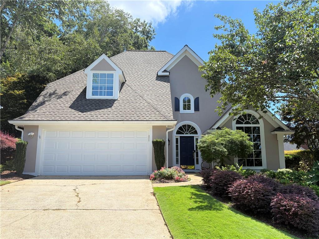 Windward Stunner that you don't want to miss! Located in the esteemed Windward Community 6125 Harbour Ridge has exclusive dock and lake access! From modern updates, open concept floor plan, new windows and roof - nothing has been missed! As soon as you walk into this home you're greeted by open first floor with light and bright engineered floor! Family room has a stone fireplace at the center with built in custom cabinets, natural light and new windows with plantation shutters. Kitchen was redone a few years ago with beautiful wood cabinets, quartz countertops, updated appliances and walk in pantry. Eat in kitchen and dining area is spacious and inviting. Sliding glass door to the patio makes entertaining a breeze. The vaulted ceilings throughout make this home warm, pleasant and move in ready. Primary suite on the main is it's own oasis with private entrance, double vanity bathroom, walk in closet, soaking tub and glass tile shower. Upstairs includes two full bedrooms and a full bathroom. Plenty of storage throughout! Backyard is private and was professionally landscaped, with a full length patio that's fenced and irrigation system for easy maintenance! Brand new roof put in 2 years ago & new hardie siding a year ago. Walk to the dock and fish or boat slips available! Windward HOA has it all! Swim, tennis, walking trails, boating rentals, pickleball, year round community events and more. A few miles from The Avalon, Golf Club of Georgia, Big Creek Greenway, Life Time, restaurants, and grocery stores.