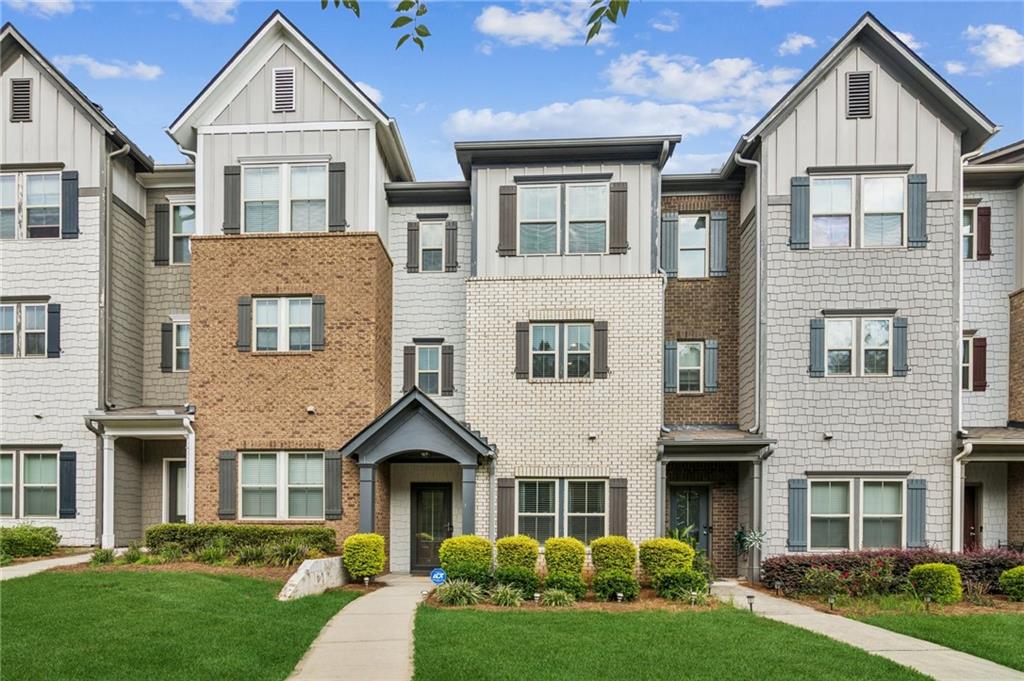 Beautifully designed, immaculately maintained tri-level townhome in coveted Lakes at Cedar Grove community! Stunning townhome features gleaming hardwood flooring, detailed crown molding. and custom designer lighting throughout. Versatile floor plan features a lower level with private bedroom, perfect for den or home office and full bathroom, ideal for guests. Upstairs, the main level unfolds into an expansive open-concept layout featuring a fireside living room, dining area with wainscoting, and eat-in chef's kitchen with center island. A sleek kitchen has painted cabinetry, granite countertops, tile backsplash, stainless steel appliances, and pantry. Bonus flex space right off the kitchen for additional dining or as currently used office nook. The private deck is accessible via French door from the living room, perfect for morning coffee or evening relaxation. Retreat to the upper level including spacious primary suite with tray ceiling and large walk-in closet, and spa bath with separate vanities, soaking tub, and separate shower. The third bedroom on this level has its own private, ensuite full bath. Private two car garage, and driveway parking. As a resident of the Lakes at Cedar Grove, enjoy access to luxe resort-style amenities including five lakes, junior Olympic pool with waterslide, pickleball and basketball courts, clubhouse, walking trails, playgrounds, and community events throughout the year. Phenomenal location walkable to shopping and dining right in the neighborhood! FHA OK! Bonus: Discounted rate options and no lender fee future refinancing may be available for qualified buyers of this home.