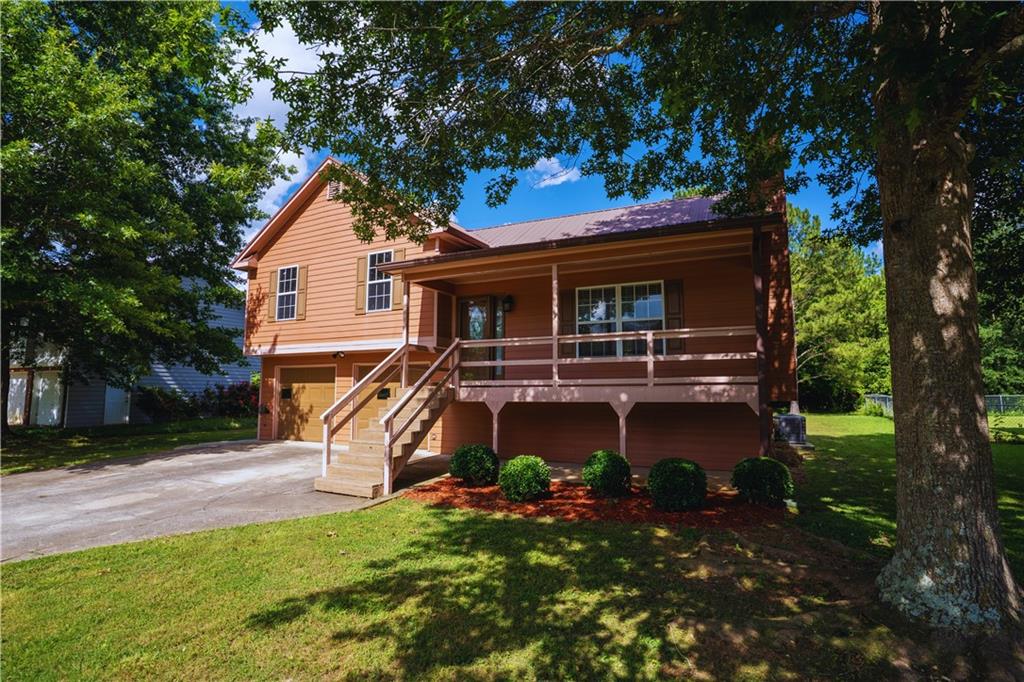Beautifully Customized Home. Don’t miss your chance to own this stunning, multi-level traditional home within Rockmart’s city limits. It offers comfort, convenience, and timeless style at an unbeatable price. As you arrive, you’ll immediately notice the charming covered front porch—a rare feature in the neighborhood—perfect for relaxing and enjoying quiet mornings or sunsets. Step inside to find gorgeous hardwood floors, striking stone accent walls, and sun-drenched living spaces that create a warm and welcoming atmosphere. This thoughtfully updated home features three spacious bedrooms, two fully remodeled bathrooms, and a versatile, oversized bonus room that is ideal for a game room, media space, home gym, or extra storage, offering endless possibilities. The kitchen is stylish and functional, boasting granite countertops, freshly painted cabinetry, and elegant tile flooring. The cozy family room provides the perfect spot to unwind, complete with a charming fireplace and fresh interior paint throughout. Retreat to the primary suite, where you’ll find a modern, upgraded bathroom with a double-sink vanity and tasteful finishes. Step outside to a generous backyard, ready for your personal touch—perfect for entertaining, gardening, or simply enjoying the outdoors. Conveniently located just minutes from Hwy 113 and Hwy 278, you’re close to local shops, restaurants, schools, banks, and more—everything you need is within easy reach. NO HOA and qualifies for 0% Down financing! Schedule your private tour today and discover all that this beautiful Rockmart home has to offer!