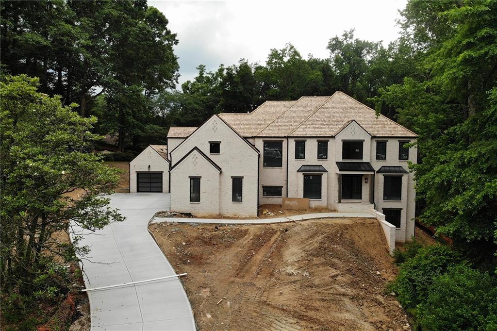 Your Sanctuary will be ready in July. Get involved now to pick your finishes with the home and pool! Custom metal doors open to highly desirable walk out main level entertaining living lanai w/wood burning fireplace, stone patio & skylights, stone decking overlooking Saltwater heated pool & spa in the private yard. This New Build offers everything the Modern Homebuyer desires. 4 side brick & stone, Cedar Shake roof, commercial-grade casement(no dbl hung)& fixed oversized black metal windows & doors throughout (no painting needed), wrapped drywal edge, wide plank hardwoods throughout, kitchen w/48" Wolf dual fuel gas range, Subzero split freezer and fridge 36" panels, dual dishwashers, beverage cooler, ice maker & micro drawer. Designer lighting, extensive 4" recessed lights, 8ft solid core doors throughout, Dual Marble Master Suites (one on main & one up) w/heated floors, custom Inset wood cabinetry in kitchen and primary baths w/Kohler plumbing fixtures throughout, full finished terrace level w/gym, media room, wet bar, rec room, full ensuite & 1/2 bath. Additional two 1/2 baths on the main level, one for the pool and one for entertaining. Elevator shaft for easy access to all levels. Quiet Culdesac location, level backyard, This home has it all!