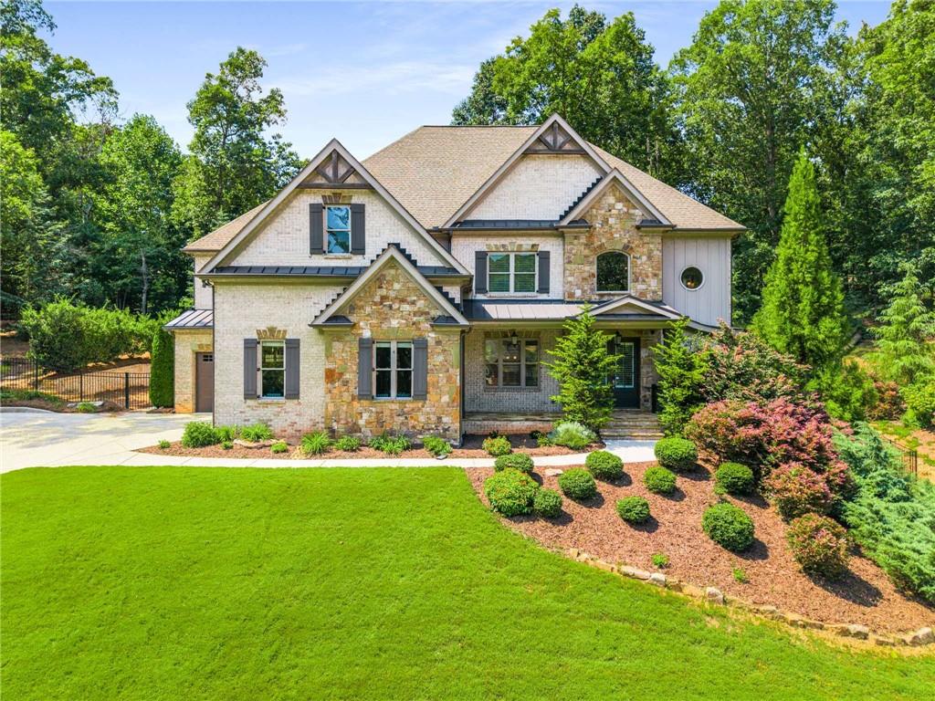 Welcome to your dream home in the highly sought-after Quailwood neighborhood, perfectly nestled at the end of a quiet cul-de-sac and surrounded by lush, mature landscaping offering ultimate privacy and tranquility. This 4-sides brick estate boasts 5 spacious bedrooms, each with its own ensuite bath, and two additional half baths, delivering both luxury and functionality across every level. Step inside to a two-story foyer flooded with natural light, enhanced by an elegant open stair rail, and be greeted by site-finished hardwoods that run seamlessly throughout all main living areas and hallways. Entertain in style in the formal dining room, showcasing a stunning shiplap accent wall, or gather in the fireside family room complete with custom built-ins. The heart of the home is the chef’s kitchen, designed to impress with an oversized quartz island, expansive cabinetry, and a custom walk-in pantry. A moving glass wall system opens to your private outdoor oasis, where a gas fireplace, stone-built grilling kitchen, and entertainment-ready patio await — the perfect setting for hosting guests or enjoying your favorite sporting events. A separate firepit area offers cozy evenings under the stars, while space remains for a small garden to satisfy your green thumb. The finished terrace level is an entertainer’s dream, featuring a movie theatre complete with sound panels and built-in speakers, offering an immersive experience without ever leaving home. Upstairs, retreat to the luxurious primary suite with a double trey ceiling, his-and-her custom walk-in closets, and a spa-like bath boasting an oversized shower with dual shower heads and quartz vanity tops. The laundry room is conveniently located upstairs for ease of access. Every secondary bedroom features tile floors and tub surrounds with quartz counters, ensuring comfort and elegance for family or guests alike. Additional features include a 3-car garage, Generac whole-home generator, attic dehumidifier, and whole-house UV light filtration system — all providing peace of mind and comfort year-round. This extraordinary home is truly the perfect blend of refined finishes, modern systems, and outdoor luxury — a rare opportunity in one of the area's most desirable neighborhoods. Half bath in terrace level can be easily expanded to a full bath, plumbing in place already.