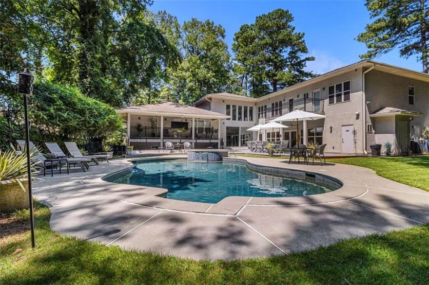 This exceptional estate features two homes on a private, expansive lot with resort-style amenities and unmatched privacy. Ideal for multi-generational living or investment, the second residence offers perfect Airbnb or rental income potential.
The main home boasts soaring windows, hardwood floors, and elegant finishes. An impressive kitchen with stone counters and expansive island opens to a bright solarium and pool deck for seamless indoor-outdoor living. The luxurious owner’s suite includes a private balcony, double shower, steam bath, and dual walk-in closets. The lower levels offer a theater, bar, billiard room, and spa area with sauna—perfect for entertaining or relaxation.
Accessibility is a priority, with wide doors, hallways, and an elevator serving all three floors, including the full guest suite with kitchenette and multiple en suites.
Outdoors, the stunning gunite pool and waterfall hot tub are surrounded by decking and balconies, set amid lush, private landscaping. A four-car garage, workshop, and custom paved driveway complete this unique estate blending luxury, privacy, and income potential.