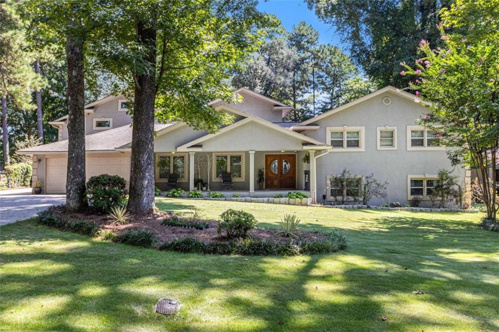 This is not a cookie-cutter traditional or trendy contemporary-it's more. More room to celebrate, entertain, and retreat. Set on a deep, wide lot at the end of a hand-laid stone driveway, this property offers two homes, a private pool oasis, and versatile spaces inside and out. Enjoy poolside living with expansive decking, private green space, a 4-car garage plus workshop, and 2 hidden extra parking spots. Unlike most new builds, this home is thoughtfully set back with exceptional privacy. The Main Home opens with a covered porch and elegant solid wood doors. Inside, light floods through soaring windows, showcasing gleaming hardwoods and soft architectural corners. The formal dining room and large island (seats 8) offer flexible entertaining options. The kitchen features stone countertops, wall-to-wall cabinetry, integrated appliances, and a walk-in pantry. Off the kitchen, a bright solarium with half-bath opens directly to the pool deck. Also on the main floor: a laundry room with storage, 2-car garage, tandem 2-car garage, and a workshop nearly the same size. Up five steps is the luxurious Owner's Suite with sitting area, private balcony, spa-like bath with soaking tub and double shower, and two walk-in closets-one the size of a bedroom. A second bedroom with full bath is also on this level. Down five steps: a home office and a sprawling entertainment level with pool table, bar, projector, multiple TVs, and access to the pool. Back to the Main Floor is a lobby with side entrance, half-bath, split staircase, and elevator to all three floors. Upstairs is a complete guest or family suite with living/dining area, kitchenette, and three oversized en suites - one with a balcony overlooking the pool. The lower level is built for celebration, wrapped in a retro 80s vibe with a full party space, spa, sauna, salon, and massage area. The showstopper is the gunite pool with waterfall hot tub, glowing at night amid lush surroundings and generous lounge space. The backyard is wide enough for both pool and play in an additional grassed space the size of another yard. This isn't just a home, it's a private retreat built for living, hosting, and enjoying. A true Showcase Home not to be missed.