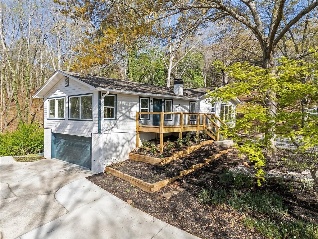 Imagine waking up to breathtaking seasonal views of Lake Lanier from your charming front porch, sipping coffee as the morning sun dances across the water. This fully renovated ranch seamlessly blends modern luxury with the warmth of lake living. Inside, an open-concept design welcomes you with flowing luxury vinyl plank flooring, a sun-filled living and dining area, and a designer kitchen boasting white cabinetry, gleaming granite countertops, stainless steel appliances, and an oversized island perfect for entertaining. Retreat to the serene master suite, where a freestanding soaking tub and tiled shower create a spa-like escape. With four bedrooms on the main level—one doubling as a sunroom—and a versatile bonus room for a home office, there’s space for every need. The finished basement offers even more flexibility, featuring a second living area, a private bedroom, and a full bath—ideal for guests or a lucrative short-term rental. Just minutes from Lake Lanier’s boat ramps, top golf courses, vibrant dining, and the North Georgia Outlets, this home is a rare find in a prime location. Whether you're searching for the perfect vacation retreat or an income-producing investment, this is lake living at its finest—don’t miss out!