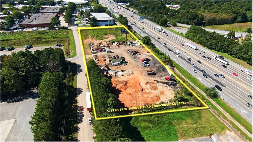 Prime Commercial LOT (including 2 parcels) on Interstate 85N frontage Road. Lot is located between Indian Trail & Jimmy Carter. Over 280,000 traffic counts a day. Prime location with high visibility from one of the populous county in GA. Currently zoned M1. Level lot with public utilities. Why pay for billboard when you can put a sign on your own building! Call for more information!