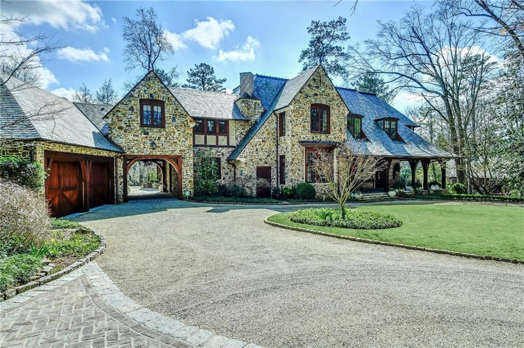 Hidden away in the heart of Buckhead, "Dancing Horse Farm" is the finest small equestrian estate in town; offering high performance equine training, pleasure riding, and leisurely hours spent exploring the woods and enjoying sports in the fields. Featuring the highest quality in construction, the main house, built in 2012, was designed by Keith Summerour with an "old world" comfort and elegance and a seamlessly flowing floor plan, perfect for entertaining a group of any size. Skillfully crafted of the finest materials, the slate-roofed stone residence was further enhanced with vintage lumber, hand-hewn white oak timbers, hand-crafted casement windows and custom ironwork. State-of-the-art systems were installed, including solar water heater, generator, security system, and cistern/rainwater irrigation. The bedroom count (5) includes the private guest house, built in 2003, with bedroom, full bath, living room and kitchen. There is also the possibility of an additional upstairs bedroom in the main house. A private, executive style office overlooks the pool and has its own full bath. The 6-stall barn is a resort level facility with a half bath in the tack room / office. This “Ritz Carlton” barn can have multiple exciting functions; it would make a great party venue, studio or gallery. To complete this extraordinary property, there are four paddocks, a beautiful pool off the back patio, 4 spacious garages plus a porte cochere, and a total of 9 partially wooded, very private acres.