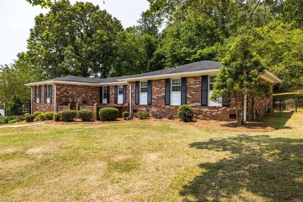 Nestled on a spacious lot, this charming brick ranch offers the perfect blend of comfort & style. With 3 bedrooms and 2 bathrooms, this residence provides ample space for you and your family. Enter through the wrought iron gate and notice a beautiful courtyard filled with lush greenery. Step inside the parquet foyer and be greeted by a warm and inviting atmosphere. The living and dining rooms are seamlessly connected to the eat-in kitchen making entertaining guests easy. The den, with new LVT flooring, is off of the kitchen and has built-in bookcases and a large wood-burning fireplace. A roomy utility room is the perfect spot for laundry, crafts, tools & storage. Retreat to the spacious bedrooms where each room is complete with new plush carpets and generous closet space. The primary bedroom boasts an ensuite bathroom, ensuring convenience. Step outside onto your expansive fenced lot complete with a garden shed. The patio makes it easy to imagine summer barbecues & family gatherings in the serene surroundings!