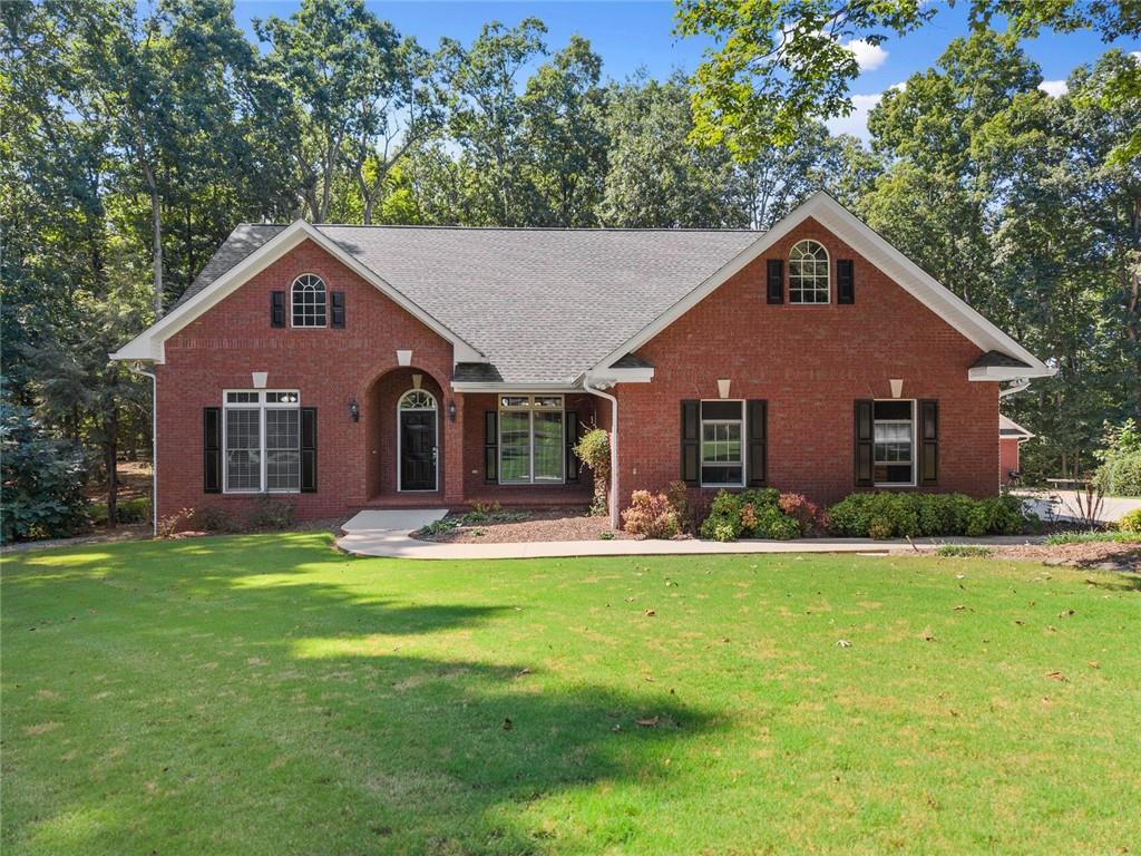 This well-maintained 4-sided brick ranch in the desirable Windmill Subdivision of Clermont offers 4 bedrooms, 3 bathrooms, and 3,870 sq ft on a quiet cul-de-sac lot with a flat, wooded backyard and huge sandbox, featuring a storm room with concrete walls, ceiling, floor, steel door, and interior steel window shutter for peace of mind; the upstairs includes a large bedroom with ample closet space plus two additional rooms perfect for an office, game room, or flex space, while the property also boasts a shop with heater, full bathroom, pull-down attic access, and power, with the home itself offering both electricity and gas, a new roof and upstairs HVAC installed in 2018, a true masonry fireplace with gas available for conversion to gas logs, and the owners are willing to sell two adjoining lots—one on each side of the property—for added privacy or expansion potential.
