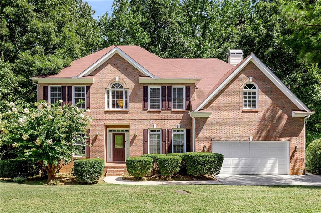**Elegant Brick Home with Soaring Ceilings & Wooded Views** This home welcomes you with a soaring two-story foyer and an expansive great room filled with natural light. The large, bright kitchen features a spacious island, stainless steel appliances, and opens directly onto a generous deck — perfect for grilling or relaxing while enjoying the wooded views. A separate dining room with a statement chandelier and a formal living room provide ideal spaces for entertaining and everyday living. Upstairs, retreat to the oversized master suite with a cozy sitting area and a unique double-sided fireplace that can be enjoyed from both the bedroom and the large whirlpool tub. The vaulted master bath offers abundant space. The unfinished basement provides endless possibilities — ready for you to finish and customize to your liking.