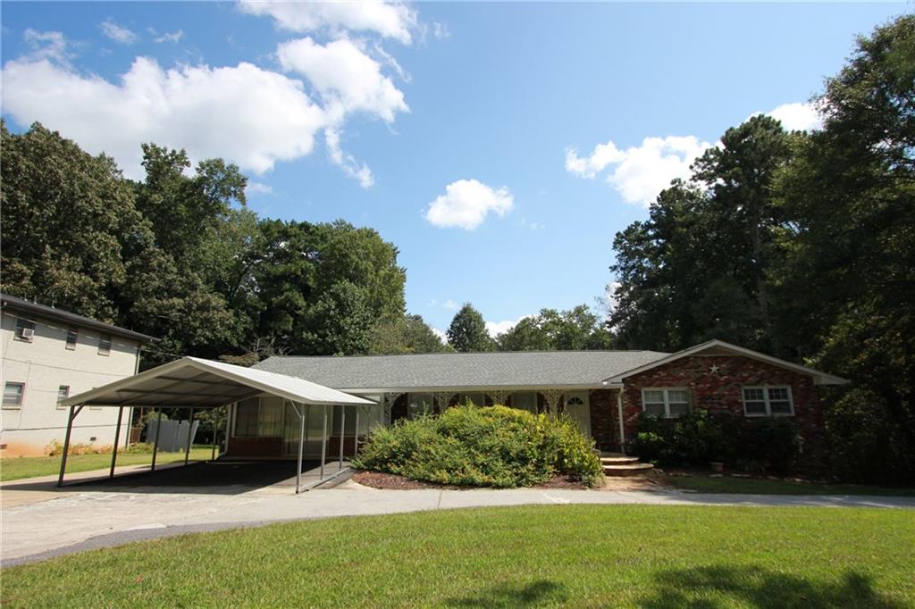 A must see! Fantastic home located in sought after area of East Cobb. This home has so much room inside and out! Home features large fireside family room, updated kitchen w/gorgeous granite, white cabinets with soft close drawers, white appliances, dining room, four seasons room overlooking the private backyard, beautiful new vinyl floors in the kitchen,family room, hall and 3 main floor bedrooms. The large bonus room off the kitchen can be used as a bedroom with a private full bath. The lower level is partially finished and has the perfect guest, in-law suite, or potential rental income with private entrance. Enjoy a refreshing drink or grab a good book & relax on the deck in private backyard. Check out the shed for storage or conversion to a she-shed, he-shed, office space! Tons of space! Convenient location, close to I-75, I-575, shopping, dining, medical & much more.