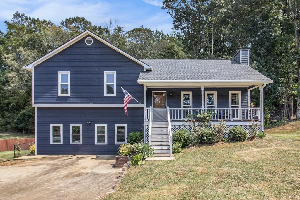 Charming Split-Level in Spencer Place, Douglasville! This delightful home sits on nearly half an acre in an established neighborhood and features a Separate 1 Bed/1 Bath In-Law Suite Apartment with its own entrance perfect for extended family or income potential. Step onto the Rocking Chair Front Porch and take in the landscaped yard before heading inside to a Bright and Open Floor Plan. Hardwood Floors, Crown Molding, and a Marble Fireplace create a welcoming Family Room filled with Natural Light. The adjoining Dining Room is ideal for entertaining and flows seamlessly into the Kitchen. A door opens to the Screened-In Porch, an inviting spot for Game Day gatherings, year-round Al Fresco Dining, or simply relaxing. Upstairs, the Primary Suite offers a Walk-In Closet and Private Ensuite Bath, while Two Additional Bedrooms share a Full Bathroom. The Fully Finished Daylight Terrace Level extends the living space with a Complete Apartment/In-Law Suite. Enjoy a Brand-New Eat-In Kitchen with Stone Countertops and Stainless Steel Appliances, a Spacious Living Area with Custom Built-Ins and a Gas Fireplace, plus a Full Bathroom with Stone Vanity and Tub/Shower Combo. This versatile space is ideal for guests, multigenerational living, or rental income. The Large, Fenced Backyard provides plenty of room to play, garden, or host outdoor fun. All this in a Peaceful Neighborhood just moments from downtown Hiram, Dallas, and Douglasville close to Shopping, Dining, and Recreation, with Easy Access to Major Highways for a smooth commute. Don't miss your chance to call this Beautifully Maintained Property your Forever Home!