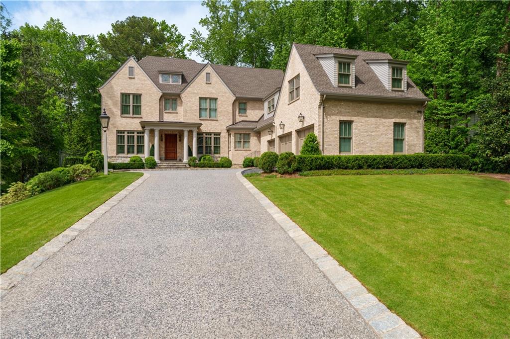 Walk to Chastain Park from this lovely home only 50 yards away with a view of the golf course from the front porch! Designed by Harrison Design and completed by Steve West, the floorplan is perfection and ideal for those seeking sophisticated finishes and expansive living spaces both inside and out. Living spaces overlook a perfectly flat and beautifully landscaped backyard with all the space you will need for a pool, play and colorful gardens.
As you enter the foyer you are welcomed by the formal dining room and private home office. Professionally designed by Stewart Mohr Designs, the color palette, light-stained wood floors and finishes throughout display an open, modern and fresh feel in each and every room. The formal living room has a relaxed feel accentuated by the wood beams and views through the oversized wall of windows of the lush greenery beyond. A butler's pantry with colorful yet refined finishes connects to dining room.
The Design Galleria kitchen is truly stunning with an abundance of cabinets and a large center island topped with elegant stone. Additional prep space and storage options are limitless with the walk in pantry, separate butler's pantry, very spacious mudroom just inside the 3 car garage. A separate home management office helps keep your busy schedules organized! The kitchen is completely open to an informal dining area and the light-drenched family room with access to the covered all-season porch featuring a cozy fireplace.
Guests will enjoy the convenience of a bedroom suite with a large closet and ensuite bath on the main level. Large cased openings connect the main stair hall to the upper level. Upstairs the primary bedroom suite occupies half of the upper level! The bath features a dramatic double shower and 2 large walk-in closets. A guest suite adjacent to the primary suite has been converted to a large dressing room with ample custom closets and a private bath. This can be easily converted back to another guest suite or nursery depending on your needs.
Two additional upstairs bedrooms feature walk-in closets and full ensuite baths, plus a large laundry room, a bonus room above the garage currently used as a gym, a full bath, and multiple closets.
The daylight terrace level is unfinished, providing plenty of space for expansion. Two floorplans are available showing the options to finish up to 2000 additional square feet on this level. An elevator shaft connects all three floors. This is a rare opportunity for such an exceptional home in this location!