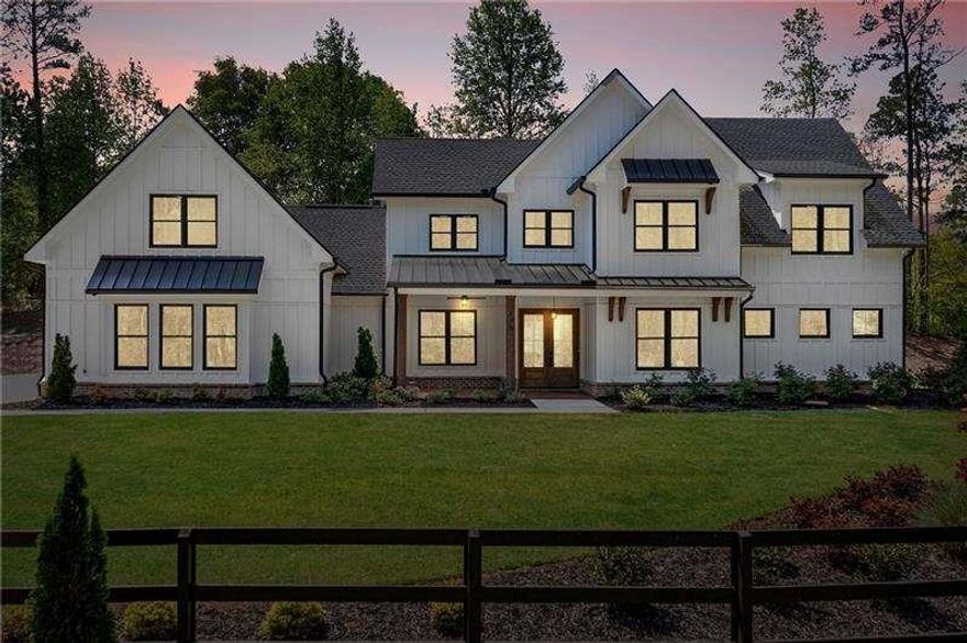 Step into timeless style and modern comfort with this stunning farmhouse retreat in Woodstock's sought-after Farm Gate community. Set on 1.38 acres of privacy and charm, this 7-bedroom, 6-bathroom estate is designed for those who crave both luxury and warmth.  Inside, soaring vaulted ceilings and natural light create an open, airy atmosphere. The spacious living room flows effortlessly into the show-stopping kitchen, where upgraded cabinets with custom inserts, exotic quartz countertops, and a farmhouse apron sink set the stage for effortless entertaining. A premium Zline appliance package-including a 36" gas stove with vent hood, microwave drawer, and refrigerator-makes every meal a chef's dream, while the oversized walk-in pantry ensures style meets function.  The primary suite is a true sanctuary with dual closets, a spa-worthy bath featuring a free-standing tub, and a Kohler shower system designed to impress. Upstairs, a finished flex space with a full bath offers endless possibilities-office, gym, or private suite.  Outdoor living is just as inviting, with a private patio perfectly placed off the dining and living areas. And for car enthusiasts or hobbyists, the expansive three-car garage provides ample room for storage, while the estate's generous lot delivers peace, privacy, and space to enjoy life at your own pace.  Farm Gate offers the best of both worlds-quiet, scenic surroundings just minutes from everyday conveniences. This is more than a home; it's a lifestyle. Don't miss your chance to make this extraordinary farmhouse your own.