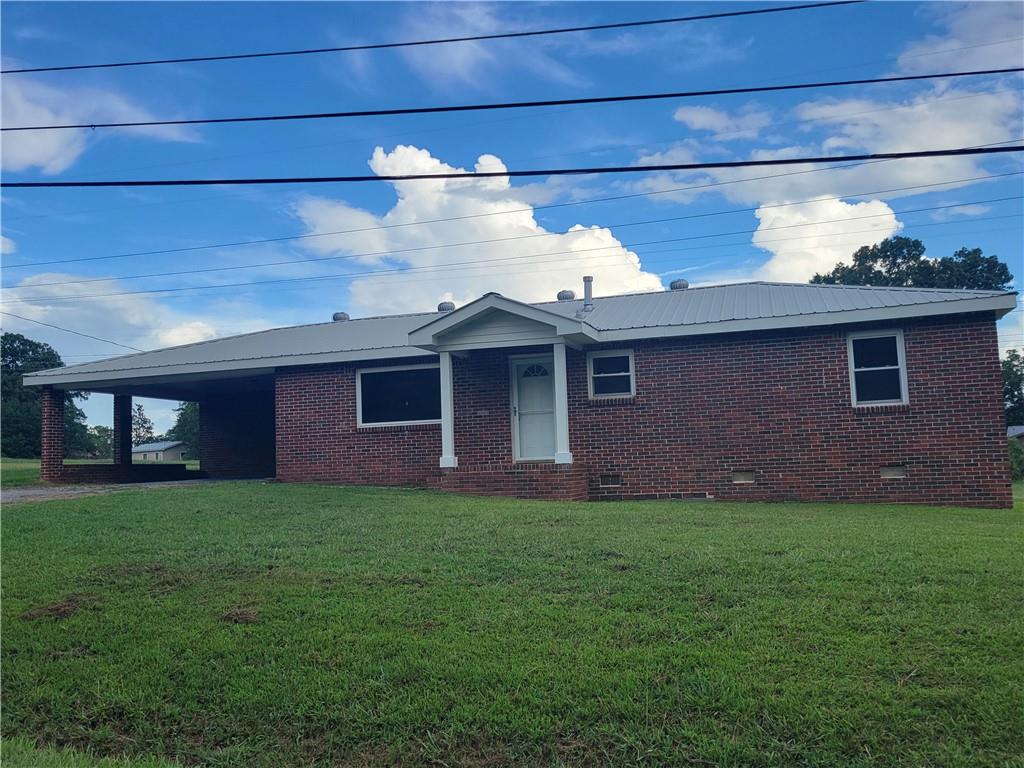 $10,000 price improvement! Great low maintenance brick and vinyl home in the Coosa school district at an affordable price! This home features hardwood floors, a metal roof, double pane windows, brand new countertop and lots of cabinets in the kitchen. Large bedrooms! This gem also offers a double carport with a storage room and sits on a large corner lot! Check it out today!