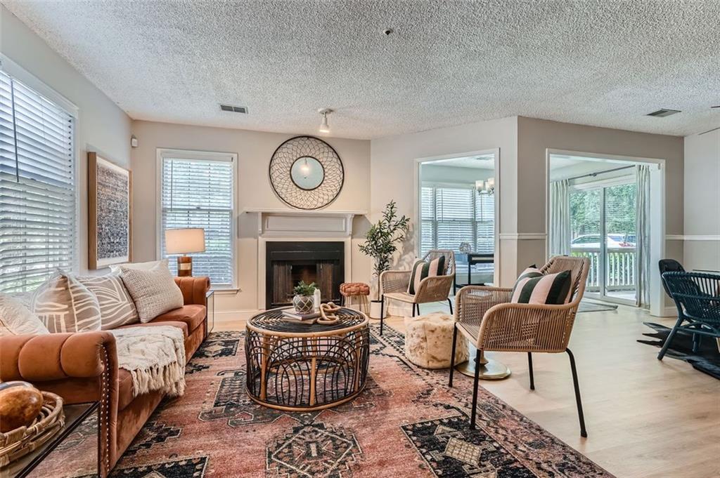 This fully renovated corner-unit condo with all-new appliances is a hidden gem, nestled in a quiet wooded neighborhood just minutes from Smyrna Market Village. Convenient parking is right outside your garden-level entrance with plenty of room for guest parking as well. Inside, find luxury plank vinyl flooring, a cozy fireplace, and an open kitchen with quartz counters, subway tile backsplash and contemporary features. The bathroom features a designer vanity with stunning herringbone tile backsplash. Spacious bedroom with a walk-in closet, and extra outdoor storage complete the home. Enjoy the beautiful neighborhood pool. Amenities also include tennis courts, a playground, gazebo, and pond.