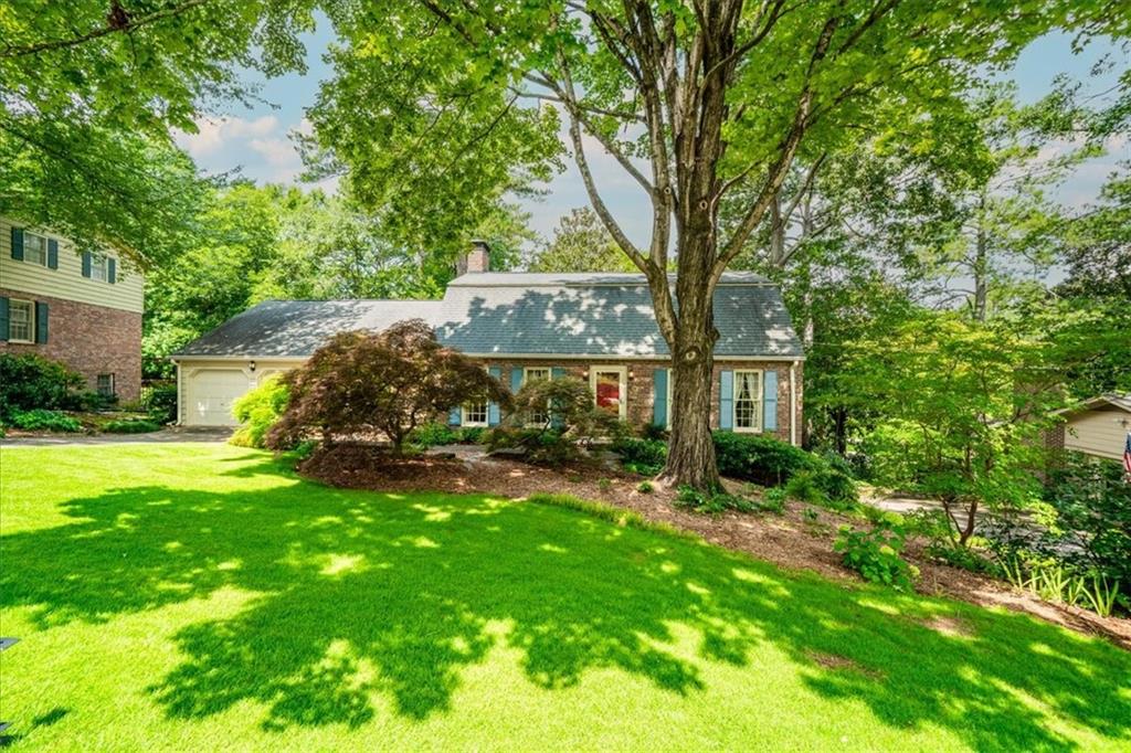 A 1969 Charmer in Country Squire Acres! Freshly painted and move-in ready, this original-owner home is located in the close-knit neighborhood of Country Squire Acres, where neighbors still stop to chat on their walks. Lovingly maintained, it boasts large rooms, a well-designed floor plan, and an incredible amount of storage. (Fun fact: An identical home was even featured in a Home and Garden sweepstakes ad in 1973!) The family room is the heart of the home with its own entrance and front porch. From there, you can access the kitchen and the screened porch, which overlooks a lovely shade garden. The kitchen, updated with Wolf cooktop, Insinkerator disposal, GE oven and Zephyr hood, Corian counters, tile back splash and under-cabinet lighting is large enough to add a center prep island. The double-door pantry includes laundry hookups, though there's also a dedicated laundry room on the lower level, complete with a laundry chute from the upper floors. A main-floor bedroom and bathroom are perfect for guests, an office, or crafts. Upstairs, the primary suite offers an ensuite bath, while two additional bedrooms share a hall bath. You'll also find access to an expansive attic over the garage. The lower level includes a rec room (finished), workshop, laundry and storage room with shelving, plus a separate storage area accessible from the yard for lawn and garden equipment. Enjoy unbeatable convenience: steps from the neighborhood pool and tennis courts, Druid Hills Middle School, Shamrock Forest (a favorite for dog walks) and the back entrance to Laurel Ridge Elementary. A mile of sidewalk takes you to Shamrock Plaza for shopping. Minutes away from Emory, CDC, Children's Healthcare and I-285. This home checks every box for space, convenience and community!