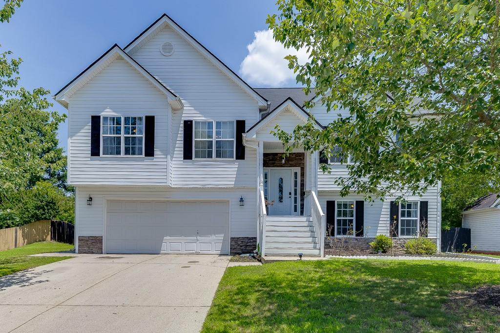 Welcome to this beautifully maintained split-level home located in the desirable Seckinger High School district in Buford. Offering 5 bedrooms and 3 full bathrooms, this spacious residence is perfect for multi-generational living or those in need of extra space. The main level features an inviting eat-in kitchen with a cozy breakfast room, white cabinets, a pantry, and a clear view into the family room highlighted by a warm fireplace. A separate open-concept dining room provides the perfect setting for entertaining. The oversized master bedroom features a tray ceiling and a newly updated floor, along with a private ensuite bathroom that includes a double vanity, separate soaking tub, and walk-in shower. Another bedroom on the main level also features new flooring, and the laundry room is conveniently located nearby. The lower level offers a full in-law suite with its own kitchen, private bathroom, and a separate entrance through the garage ideal for guests or extended family. Enjoy peaceful mornings with stunning sunrises from the back deck overlooking the large, fenced-in backyard, complete with a fire pit and level yard for outdoor activities. A newly installed front-facing fence adds charm and privacy to the property. The two-car garage includes a laundry hook-up, and both private front and rear entrances enhance the home's accessibility and functionality. This home blends comfort, flexibility, and thoughtful updates in a prime Buford location.