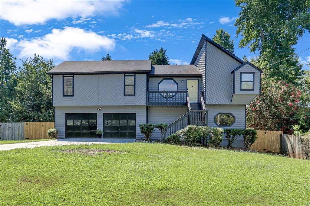 This wonderful 4 bed 3 full bath split-level home is move-in ready. It’s just waiting for your special touches! Located in the well established non-HOA community of Quinn Ridge, just minutes from shopping, grocery, dining, entertainment and parks, including Stone Mountain and Yellow River. Very convenient to Scenic/Centerville Hwy (124) and Hwy 78. This freshly painted exterior and interior beauty has a private, fenced backyard complete with double balconies as well as a front balcony, where you can relish the remainder of the summer months in style. Inside you will enjoy your eat-in breakfast room & separate dining room both beaming with sunlight just off the large kitchen featuring loads of counter space with backsplash, tons of cabinet space, ss appliances, and beautiful tiled floors. The family room has a vaulted ceiling, hardwood flooring and is equipped with a stone fireplace to cozy up for the cooler months. The expansive second living area downstairs includes an en-suite bathroom with a brand new shower and personal walk-out to the backyard deck. This area is sure to give even more comfortability no matter how large or small your family is. The extra large garage equipped with working space & shelving completes this great home. Call for your private tour to see this home today!