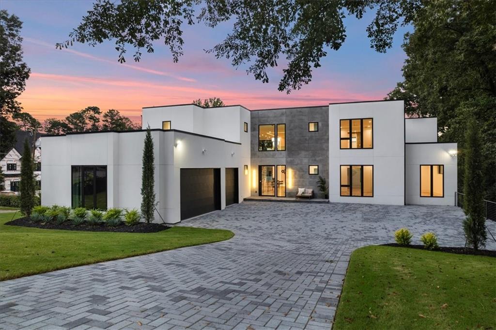Extraordinary contemporary new construction home on quiet street in Chastain Park is now complete and move-in ready. The sprawling home is bathed in ample sunlight throughout the day and welcomes you into a breathtaking two-story foyer and great room with view to an elegant chef's kitchen complete with handsome custom cabinetry, Wolf and Subzero appliances, an oversized island with seating for 8, and a hidden scullery and pantry. Bright wide-plank walnut hardwoods flow through each living space, and the home is already equipped with an elevator to service all three levels. The thoughtfully designed home provides an expansive Owner's suite with a cozy fireplace and glass doors leading to the outdoor area. Double doors lead into the oversized marble and venetian plastered bathroom with generously sized dual vanities and his and hers water closets. Through another set of double doors leads into a massive closet - substantial enough to fit two large islands, furniture, and currently a blank canvas for buyers' taste of luxurious custom shelving to suit. Just beyond the great room, walk out onto a large deck complete with pool and spa for instant gratification. Upstairs features three additional spacious ensuite bedrooms and a secondary living space. The finished terrace level offers 11" ceilings, a second full kitchen and living area with a full view to a gorgeous glass wine cellar. A large gym, media room, large bedroom and full bath, plus additional unfinished space for ample storage. Home is already wired for Smart Home system and invisible speakers are already installed on main level. No detail has been overlooked to effortlessly make this home yours.