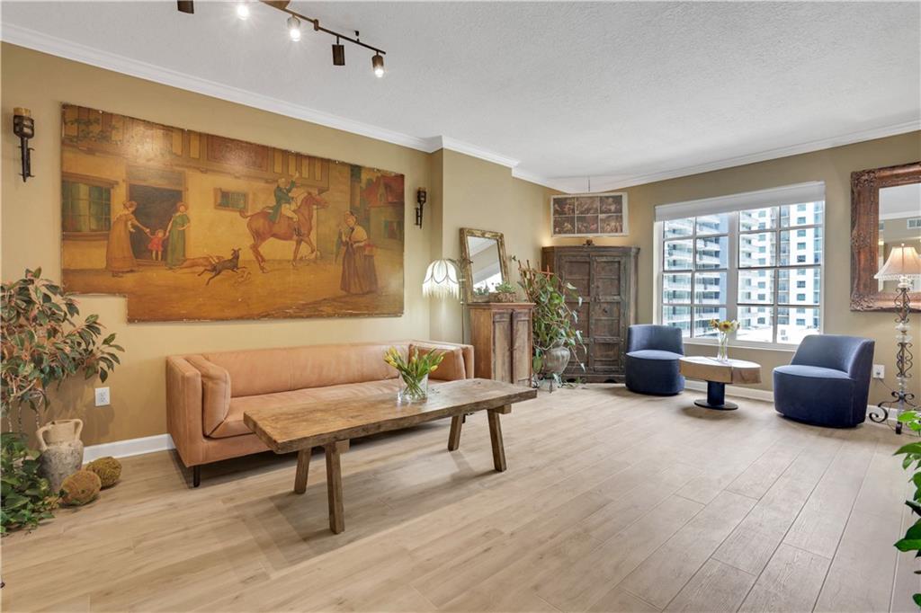 Sophisticated Midtown Condo with Eastern Sunrise Views over Piedmont Park! Modernized One Bedroom Floor with Designer Finishes Throughout. Well-Equipped Updated Kitchen, SS High-End Appliances and Quartz Counter with Extended Breakfast Bar. Freshly Updated Bathroom including a Stylish Rainfall Shower with Sleek Porcelain Tiles and Sliding Glass Doors. Laundry Closet wit Brand New Whirlpool Stackable Washer and Dryer Included. Beautiful Hardwood LVT Aqua Guard Flooring Highlighted Throughout with an Abundance of Windows and Natural Light. Newer HVAC with Sanitizing UV Light. Private East Facing Walk-Out Patio Overlooking the Tree Canopy of Midtown and Beyond. 1 Deeded Covered Parking Space on the Second Floor. Quality Amenities including 24-hour Concierge with On-Site Management. Community Features Amazing Amenities Including a Panoramic Rooftop Terrace, Outdoor Pool, Grilling Area, Club Room, Dog Walk, Google Fiber, and more. Building Has a High-End Fitness Center with Cardio Room, Weight/Machine Room, Yoga/Boxing Studio, Saunas, and Unique Indoor Heated Lap Pool. One Bedroom Guest Suite with Dedicated Parking Spot. Full-Time Onsite Management and 24-hour Concierge Service. Just Steps Away from Piedmont Park, the Woodruff Art Center, Colony Square, Close to Marta Stations, and All of the Dining and Entertainment Options Midtown Has to Offer!