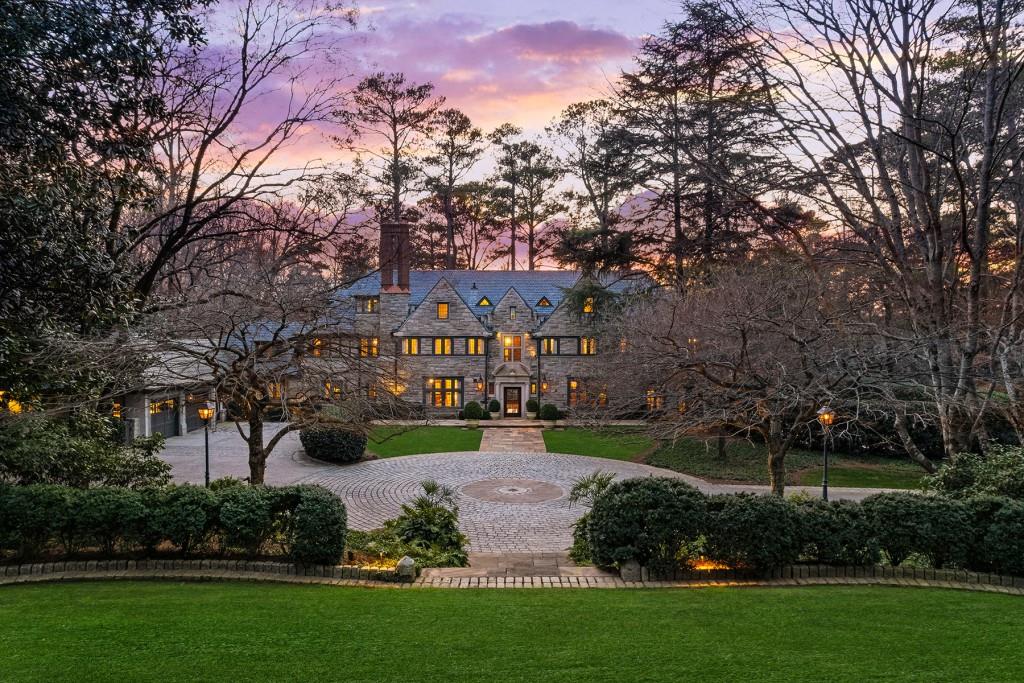 One of Atlanta's most beautiful estates, 3015 Andrews Drive was originally constructed in 1929 and was later expanded for today's lifestyle by renowned architect, Keith Summerour. Sited on nearly 3 acres, the home welcomes with the gated driveway leading to the large motor court. This stunning estate is designed with entertaining in mind. The welcoming foyer is flanked on either side by the formal dining room and formal living room which leads to the bright stone garden room with French arched doors. The cozy family room is adjacent to the fireside kitchen with a La Cornue range, two Sub-Zero refrigerators, two dishwashers, ice maker, large center island and breakfast area. There is also a butlers pantry located adjacent to the kitchen. Upstairs is the owner's suite with his and her baths and separate closets. Three additional bedrooms complete the second level of the home - one of these bedrooms has been converted into a stunning custom closet. On the third floor of the home is a great suite complete with sitting/TV/play room, one bedroom and full bathroom. On the terrace level of the home is a TV room, wine cellar and gym. In the separate carriage house is a kitchenette, living room, bedroom, full bath and two-car garage. The exterior of the home is equally as stunning as the interiors, featuring a pool, flat play yard and multiple terraces overlooking the mature landscaping, which was thoughtfully designed by John Howard with Howard Design Studio.