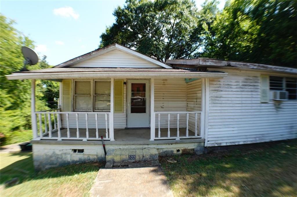 This two-bedroom, one-bath home sits on TWO deeded parcels totaling 11,326 sq ft, offering excellent potential for renovation, expansion, or investment. The property features a basement foundation and a carport located on the second parcel, providing added flexibility and value. Inside, you're greeted by a comfortable family room that flows seamlessly into the dining area and kitchen. The kitchen offers direct access to the back patio with stairs access to the basement. Down the hall, you'll find a linen closet, the first bedroom, and the generously sized primary suite, which includes two closets. The full bathroom is spacious and functional. Conveniently located near downtown Rome, schools, and shopping, this home's solid construction and prime lot size make it an ideal choice for buyers seeking a project with lasting value.