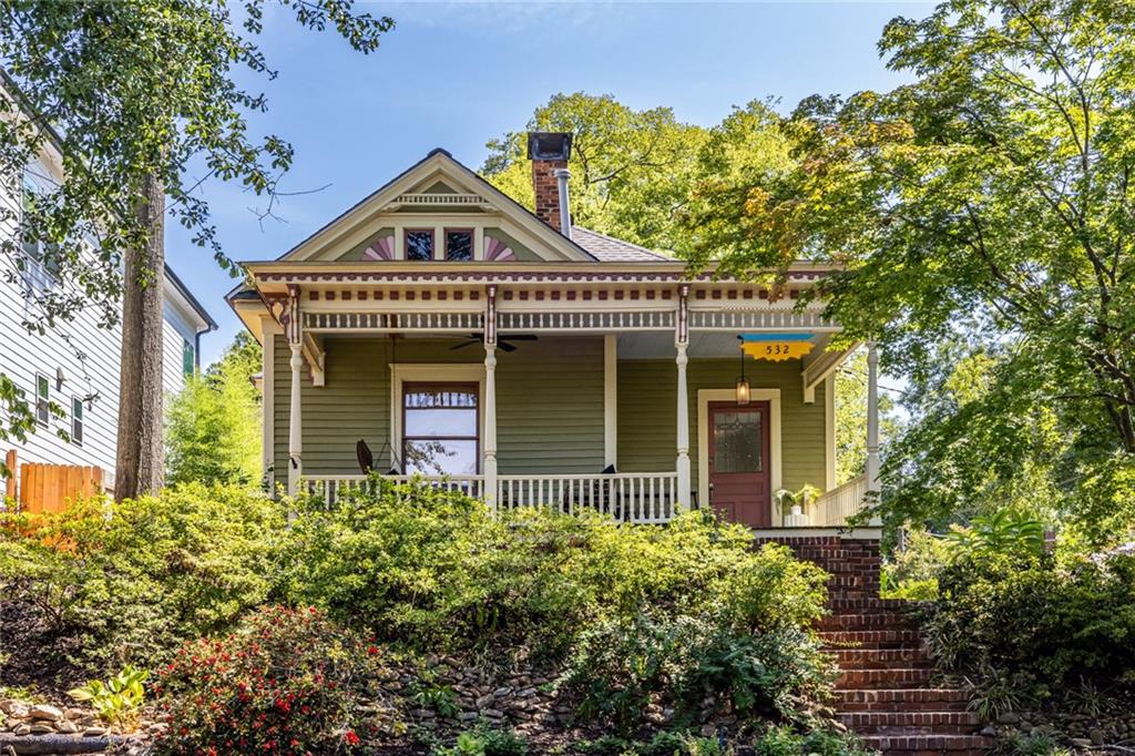 Dream Location in Historic Grant Park Nestled in the heart of Grant Park, this charming 1920s Victorian bungalow offers the perfect blend of timeless character and modern updates. Perched high on a landscaped, private lot, the home enjoys wonderful views?including glimpses of downtown?and a storybook front porch that welcomes you in. Inside, the main level features two bedrooms and two full bathrooms. The spacious primary suite boasts an updated bathroom with a walk-in shower, frameless glass, and abundant natural light. A second renovated bathroom complements the additional bedroom. Living and entertaining are easy with a stylish kitchen, dining room, and inviting living room that showcase the home?s classic details. Upstairs, a hardwood-floored bedroom with a full bath provides excellent flex space?perfect for in-laws, guests, or a home office. The location is truly a 10/10: just steps from Summerhill, Grant Park, neighborhood schools, and with quick access to I-20, downtown, and everything Atlanta has to offer. A low-maintenance yard, garage slip at the back, and years of loving care make this home as practical as it is beautiful.