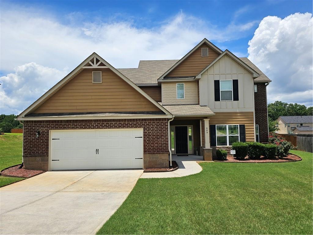 Welcome to this stunning 3 sides brick craftsman style home which offers an oversized primary suite on the main. A grand two-story family room creates the perfect setting for gatherings and memory making. Upstairs, you'll find three generously sized bedrooms, a loft area and two full baths with plenty of room for family or guests. All bedrooms have direct access to a full bath. At the heart of the home, a thoughtfully designed open kitchen features a coveted double oven perfect for cooking, baking, and entertaining with ease. Offering ample counter space and storage. Step outside to enjoy a large, fully fenced backyard safe and spacious for kids and pets. The screened-in rear porch offers a peaceful retreat for morning coffee or evening unwinding. Families love the easily walkable sidewalks dedicated throughout this beautiful community. Located in walking distance to Ola High, Middle and Elementary schools. Don't miss the chance to make this inviting family haven your forever home!