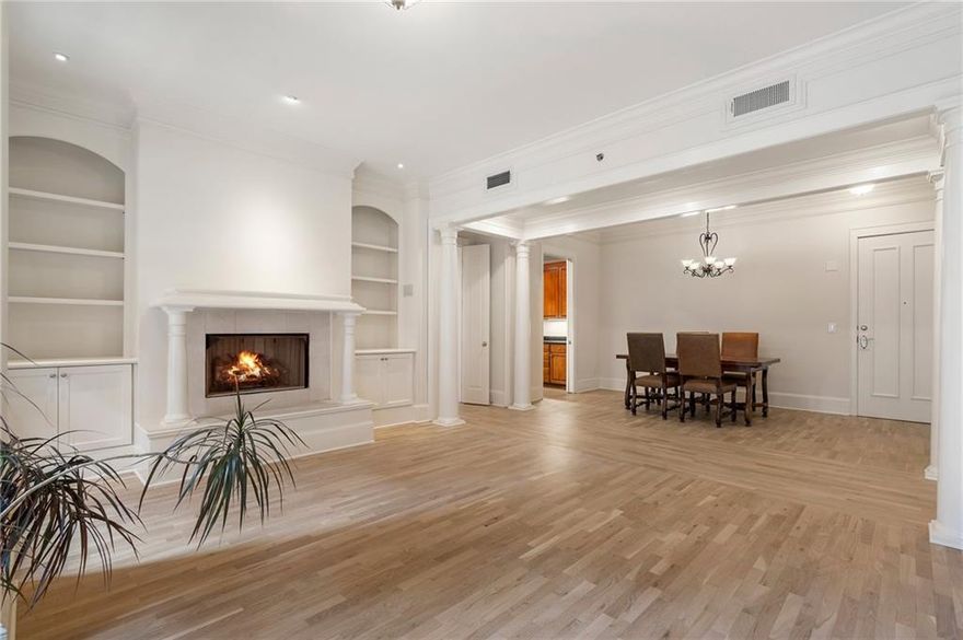 Discover timeless elegance and modern convenience in this spacious 2-bedroom, 2-bathroom condo located in Cotting Court, one of Midtown's most charming boutique buildings. This well-maintained home features newly refinished hardwood floors and fresh paint throughout, offering a move-in-ready canvas for your personal touch. The efficient galley kitchen is both stylish and functional, boasting warm maple cabinetry, and sleek granite countertops. Adjacent to the kitchen, a central hallway opens into a generous dining area and living room, complete with built-in bookshelves and a cozy gas fireplace—perfect for both everyday living and entertaining. Retreat to the enclosed primary suite, where a spacious walk-in closet and a serene bathroom with a relaxing soaking tub await. The second bedroom provides flexibility for guests, a home office, or a personal gym. A full-size washer and dryer are conveniently located off the kitchen. Step out onto the private balcony overlooking the serene pool deck on the third floor, offering a peaceful outdoor escape. Residents of Cotting Court enjoy top-tier amenities, including a well-equipped gym just off the lobby, a tranquil pool area, and the convenience of a 24/7 concierge. Condo fees cover essential utilities such as water, gas, trash/recycling, high-speed internet, and cable, simplifying your monthly expenses. The unit includes two dedicated parking spaces in a secure garage. Perfectly positioned for Midtown living, this condo is just a short walk to MARTA, Piedmont Park, and the neighborhood's best restaurants, shops, and cultural attractions. Don't miss the opportunity to own this spacious, elegant condo in the heart of Atlanta's vibrant Midtown district. Schedule a tour today!