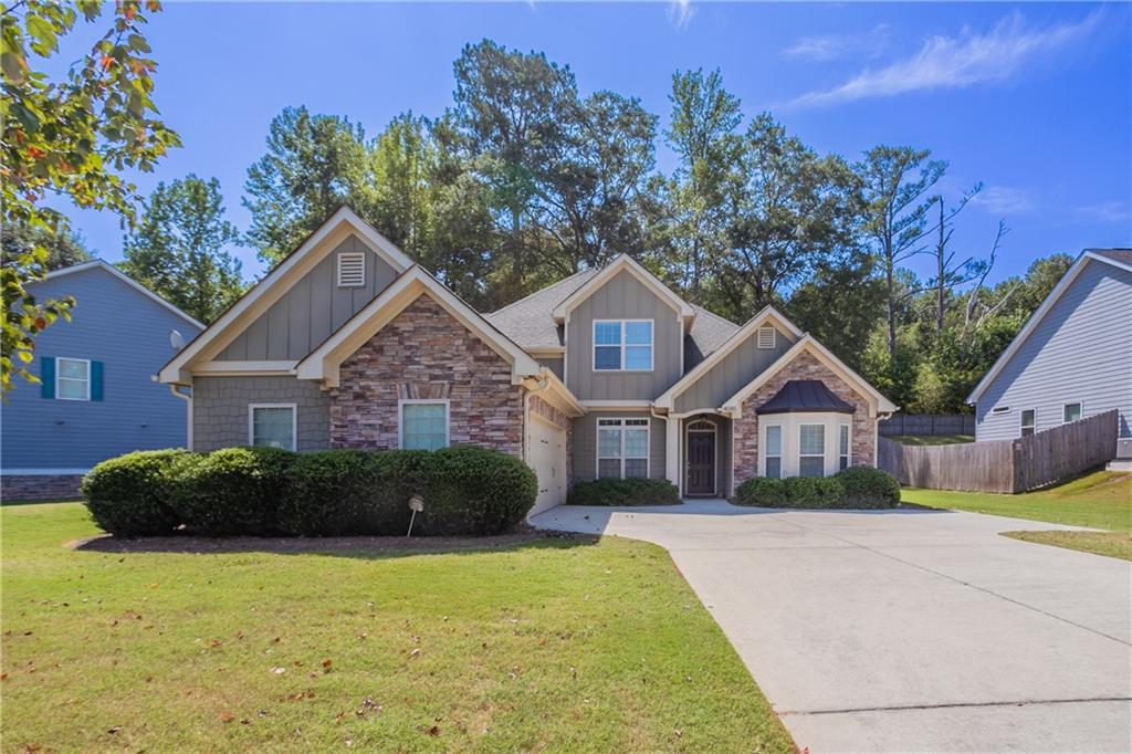 Beautiful two-story home in the desirable Stonebrook community, offering a primary suite on the main level and a spacious open floor plan. The family room features a cozy corner fireplace and connects seamlessly to the kitchen with stained cabinets, pantry, and breakfast bar. The main-level primary suite includes double vanities, a whirlpool tub, and a separate shower, while the upstairs bedrooms provide privacy and flexibility with their own full bath. Enjoy outdoor living on the covered grilling porch with ceiling fan, perfect for year-round relaxation. Neighborhood amenities include sidewalks, playground, pool, tennis courts, and street lights. Conveniently located near shopping, dining, and major highways, this home combines comfort and community living.