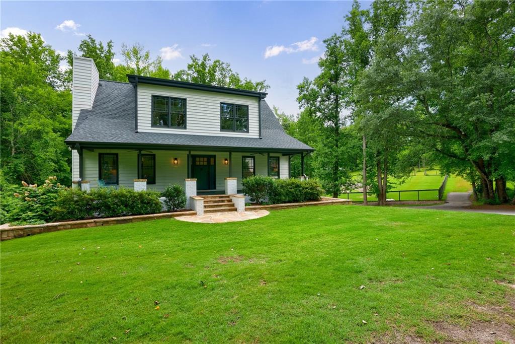 **MOTIVATED SELLER** A farm style home in the city combines rustic charm with urban convenience. The exterior features weathered wood siding and porches on both the front and back side. Inside the home is warm and inviting, with pine hardwood floors, stone fireplace, and freshly painted walls. Bedroom 1 is located on the main floor and the ensuite bath features a clawfoot soaking tub and separate shower. Bedrooms 2 and 3 are upstairs with a shared full bath. Also, upstairs is a playroom and loft area. The fully finished terrace level has an additional bedroom, full bath, family room, and laundry. The home sits on 3.3 acres. It has a large saltwater pool that is fenced and gives kids plenty of room to play. This private retreat offers a peaceful escape while still being close to city amenities and top schools.