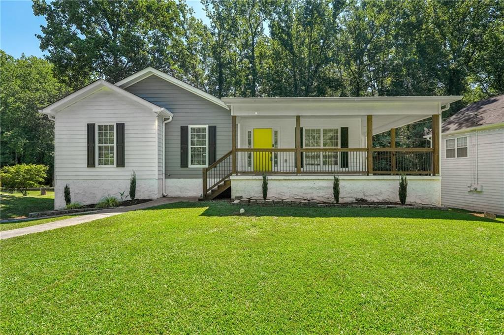 Beautifully Updated Home with Income Potential on a Quiet Street! This charming and fully updated home offers bright, open spaces and incredible flexibility—including income-producing potential! Situated on a peaceful street with a huge, sweeping front lawn, the home greets you with a large Southern-style front porch—perfect for rocking chairs and relaxing evenings. Inside, you'll find stylish, low-maintenance laminate wood floors throughout the entire main level—no carpet! The sunlit living room features vaulted ceilings and a striking accent wall, while the modern kitchen is a true showstopper with quartz countertops, a herringbone tile backsplash, stainless steel appliances, on-trend white cabinetry, breakfast bar, and under-cabinet lighting. The dining room overlooks the private backyard and offers easy access to the deck—ideal for al fresco dining. A spacious laundry room is conveniently located nearby. The serene primary suite is a true retreat, with a tray ceiling and an updated spa-like en-suite bath featuring dual sinks, a pedestal soaking tub, and a custom-tiled frameless glass shower. Two generously sized secondary bedrooms and an updated full bath offer comfort and space for everyone. Need more room—or looking to generate rental income? The fully finished basement is ready for anything! Featuring a large living area, full kitchen with island, bedroom, full bath, and a separate private entrance, this space is perfect for a guest suite, teen hangout, home office, or an income-producing Airbnb or long-term rental. (Ask about the option to purchase fully furnished!) Step outside to enjoy a spacious upper deck for grilling and entertaining, plus a covered lower patio with even more room for relaxing. A large driveway and 2-car garage provide plenty of parking, and the oversized lot offers space to build additional storage or structures—all backed by the privacy of peaceful woods. Don’t miss this rare opportunity for flexibility, style, and investment all in one!