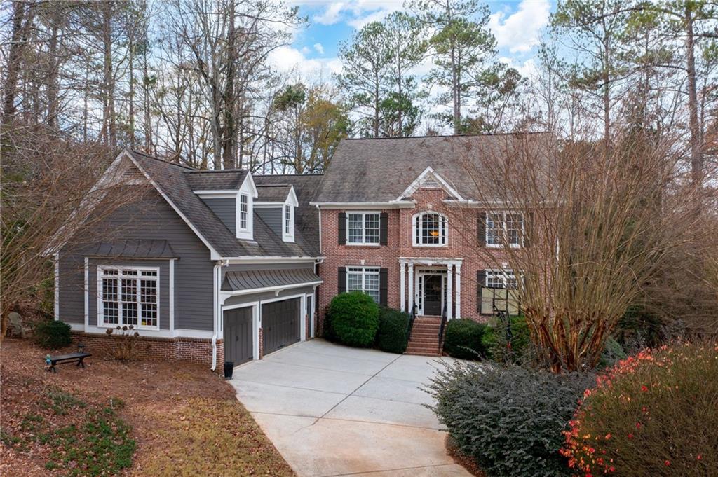 Welcome to this stunning executive home nestled on a sprawling cul-de-sac lot of nearly an acre in the highly sought-after McDaniell Farm! A true rarity, homes in this tucked-away West Cobb gem are seldom available, offering families an unparalleled location and lifestyle. This home boasts an exceptional layout with the primary suite on the main level, a spacious open-concept design, and exquisite millwork details throughout. The fireside family room features a coffered ceiling, creating a warm and elegant centerpiece for the main level. A mudroom, wet bar, home office, and formal dining room add to the thoughtful functionality of the space. Three car garage features a 240 volt Tesla charger. Upstairs, you'll find four generously sized bedrooms, two full baths, and a bonus playroom/office that provides versatility for modern living. The finished terrace level is an entertainer's dream, complete with a second family room, billiard area, home gym, office, and an additional bedroom suite. Step outside to experience the perfect blend of relaxation and entertaining with two distinct outdoor spaces: a custom fireplace under the deck and a rock walkway to the firepit in the fenced backyard. With its prime location minutes from Barrett Parkway, Marietta Square, and all that West Cobb has to offer, this quiet community provides the best of suburban living with easy access to everything.