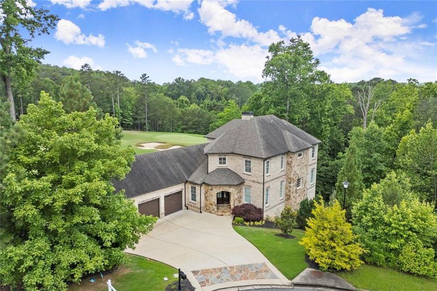 Set on a 1-acre lot amidst lush conservation areas, this custom-designed 5-bedroom, 4.5-bath home boasts stunning views and exceptional craftsmanship. The impressive 4 side brick and stone exterior is highlighted by custom double wood French doors. Soaring 12-foot ceilings, hardwood floors, freshly painted walls, and upgraded light fixtures throughout. The gourmet kitchen is a chef’s dream, equipped with a large island, premium JennAir appliances, a farmhouse sink, soft close drawers and doors and a custom walk-in pantry. The main-level master suite provides a private sanctuary with double vanities, a spa-like shower, and a custom closet. Upstairs, three additional bedrooms, including a second master suite with a soaking tub, walk-in closet, and dual vanities. The expansive two-story basement with 12 and 19 foot ceilings is filled with natural light and features energy-efficient spray foam insulation, providing endless opportunities for customization. A three-car garage adds to the home’s exceptional features. The beautifully landscaped two-level backyard offers a private escape, with the lower section recently cleared of trees for an open, inviting space. The backyard also features a newer retention wall and irrigation system. Echelon, a gated luxury golf community in Alpharetta, GA—known as “Atlanta’s High Country Estates”—offers expansive homes on large lots, a premier golf course, a clubhouse, and breathtaking views of rolling hills and serene lakes. Residents enjoy top-rated schools, fine dining, and shopping, all while being just a short drive from the vibrant heart of Alpharetta and Milton.