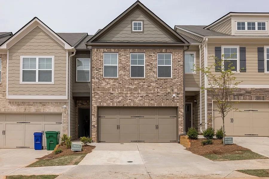 Welcome home to this modern townhome with a charming brick front exterior and an inviting open-concept design. The main level is perfect for everyday living and entertaining, featuring a spacious family room with a cozy fireplace that flows into the bright kitchen with a large island breakfast bar, crisp white cabinets, a pantry, and a generous dining area where everyone can gather. Upstairs, the owner’s suite offers a peaceful retreat with a tray ceiling and a spa-like en-suite bath complete with a double vanity, soaking tub, and separate shower. The secondary bedrooms are comfortably sized, making them ideal for family, guests, or a home office. Step outside to enjoy the level fenced backyard with a patio, perfect for relaxing evenings or weekend cookouts. All of this in a convenient location just minutes from Covington Highway and Panola Road, with easy access to I-20 and I-285 for quick commutes around the city.