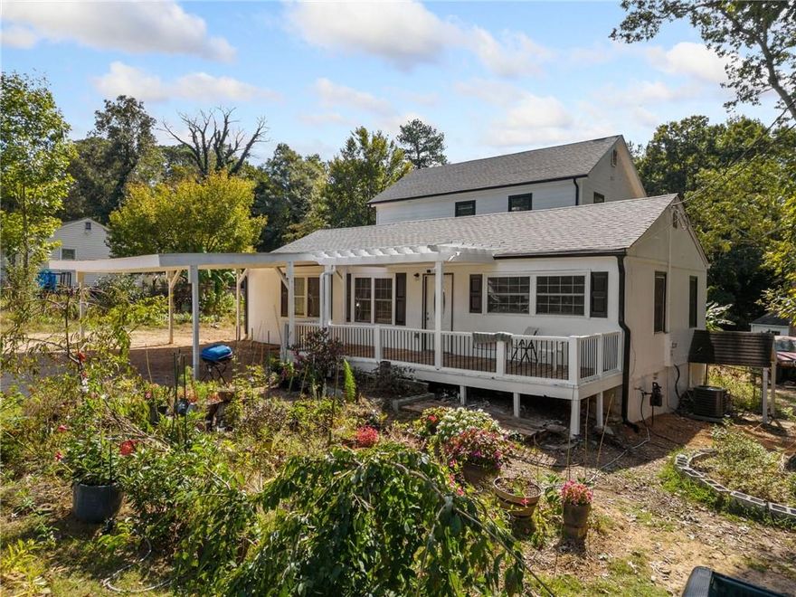 If you have been searching for an affordable home in the heart of Marietta with many bedrooms, this is the one for you! This move-in ready home has been expanded to accommodate 6 bedrooms and 3 full baths, with all the work being done with permits and up to code, and the septic has been expanded. This home offers fresh paint throughout, new LVP flooring through most of the home and the rest being tile or hardwoods, one of the zoned HVAC units is new, and a brand new roof! As you make your way into the home from the large porch you are greeted by a spacious living room that flows to the kitchen with granite and a tiled backsplash and the open dining area. There are 3 bedrooms and a full bath off the living area with an appealing split bedroom plan for the oversized primary bedroom, which is almost brand new and offers a large walk-in closet and bathroom with tiled floors and tiled tub/shower. Upstairs you will find 2 more good sized bedrooms and a 3rd full bath. The home also offers 2 walk-in crawl space areas that are great for storage along with a large outbuilding. The yard has been lovingly planted with all types of flowers and plants to enjoy almost year-round. Make sure you do not miss this home, which offers so much space in an amazing location convenient to everything Marietta has to offer!