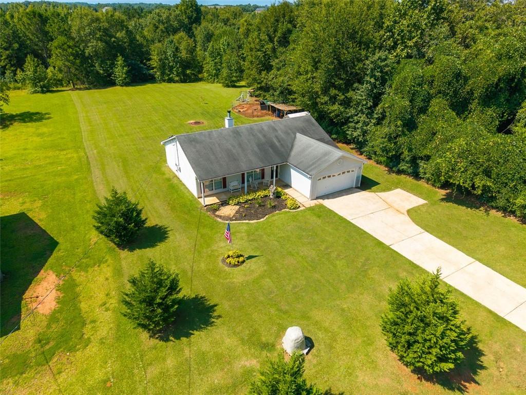 This 3-bedroom/2-bath property sits on a spacious 1 acre lot, offering the perfect blend of rural living with convenient access to downtown Thomaston. The spacious living room features a cathedral ceiling and wood-burning fireplace. It has galley style kitchen, that leads to the dining room. The mudroom is covently located right as you come in from the garage. The secondary bedrooms have floor to ceiling windows, large master with cathedral ceiling, master bath feature garden tub and separate shower. It includes a large yard with plenty of room for outdoor activities, ample parking, and a recently cleaned septic system professionally serviced in December 2024 for added peace of mind. Don't miss this chance to own a great home in a desirable location with long-term value.
