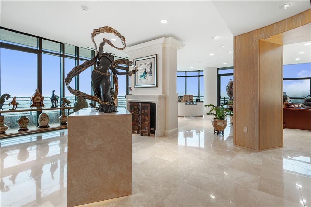 4500+sf Elegant Polished Stone Floor Unit on 32nd Floor Overlooking Buckhead
- Private elevator opens directly into unit with additional private service elevator
- Private 1200sf three car garage
- 150 linear feet of private balcony with panoramic city view
- Massive his (approximately 200sf) and hers (approximately 400sf) Master walk in closets
- Designer chef’s galley kitchen open to living and dining areas
- Third bedroom configured as office/studio space


As you arrive home to 750 Park Avenue, you can either park yourself in your 1200sf three car garage, or pull up to the covered porte cochere and have the valets park it for you. Today you opt for the valet, and enter the lobby to get on the elevator that opens directly into your home on the 32nd floor.

You step off the elevator into your home and are greeted by a huge foyer. The current owners have it set up as an art gallery, but can also be used as a reception area, a formal living room, or even another office space. The floor to ceiling windows throughout the unit offer abundant light when desired, and the roll down shades throughout provide privacy.

Double doors lead from the foyer to the spacious open floor plan kitchen, living, and dining area. A galley style chef’s kitchen is built around a huge white granite top island with integrated bar height seating. A wet bar with ice maker and full size dual zone wine fridge make entertaining in this space an absolute dream.

Following a hallway out of this area leads to a very large 300sf bedroom, followed by the massive (approx 400sf) master bedroom. Unique to this home’s master is both his and her bathrooms and closets.

The “his” bathroom is finished in all marble, floor to ceiling, and features a huge shower. “Her” bathroom opens into a 200sf lounge/dressing/exercise area and then into a bathroom with vanity, tub, and marble shower.

Accessible from the master are also the his and hers walk in closets. “His” closet is an impressive almost 200sf with a dressing island with integrated safe. “Her” closet is an astonishing almost 400sf and over 400 linear feet of double height hanging space, as well as a dressing island also with an integrated safe.

You receive a notification from Brian at the front desk, who has been working at Park Avenue for 20+ years, that you have a package that has been delivered, and at your request, he is sending it up in the elevator.

Life at Park Avenue is the ultimate in convenience and luxury. Schedule an appointment to experience it for yourself.